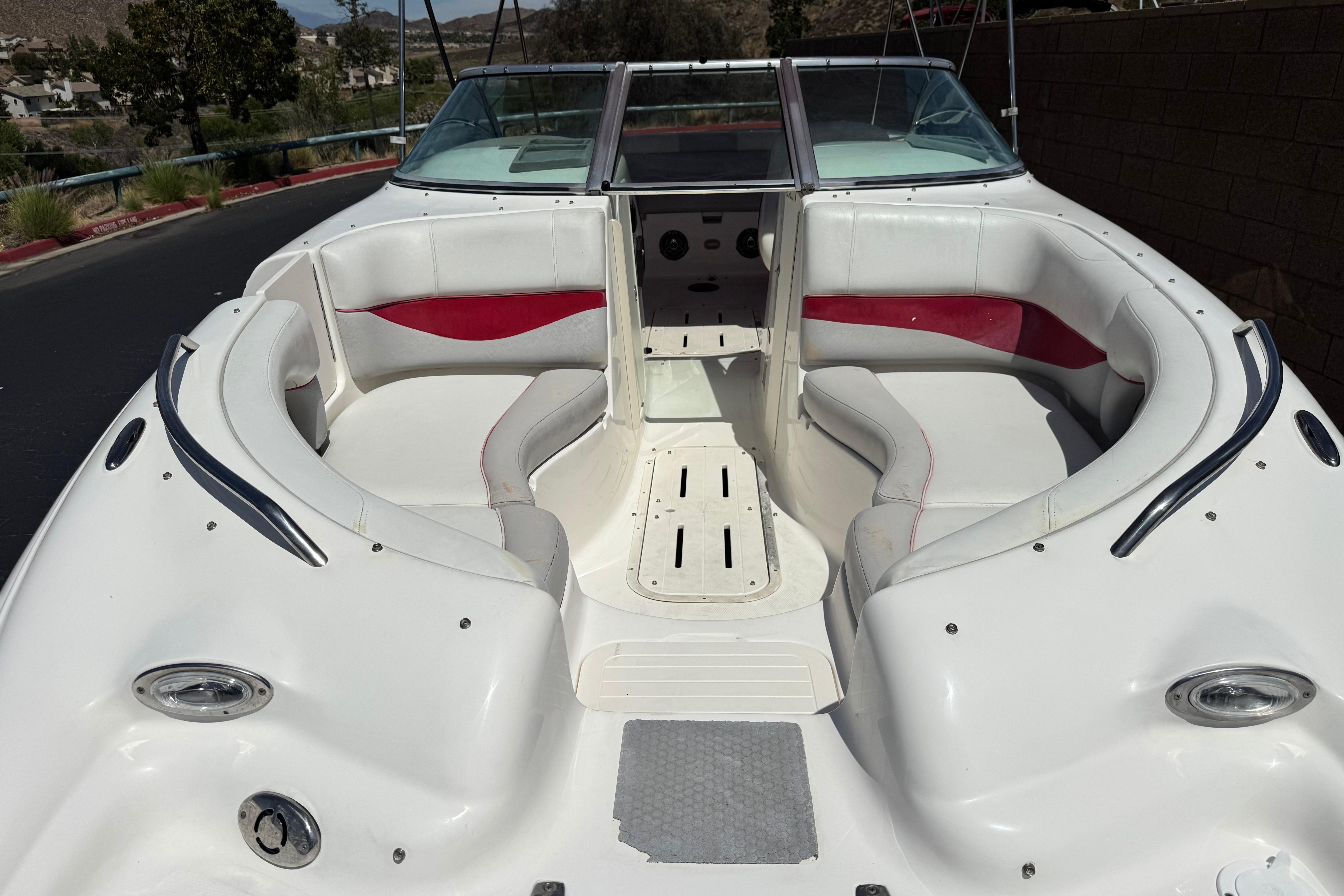 2010 Bryant 255 boat interior with white and red seating, open bow design.