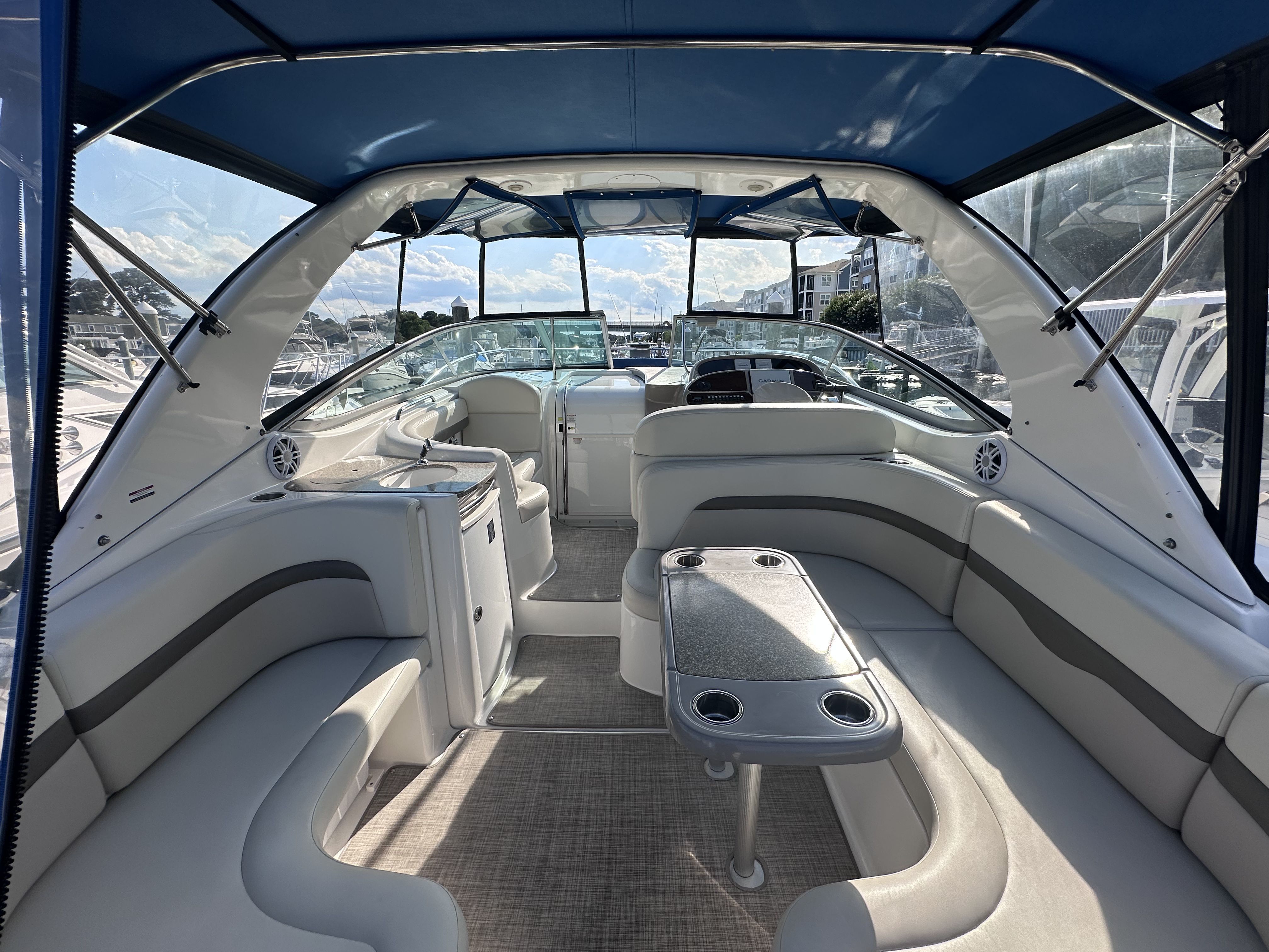 The image shows the cockpit of a 2008 Chaparral Signature 330 with blue accents and gray upholstery.