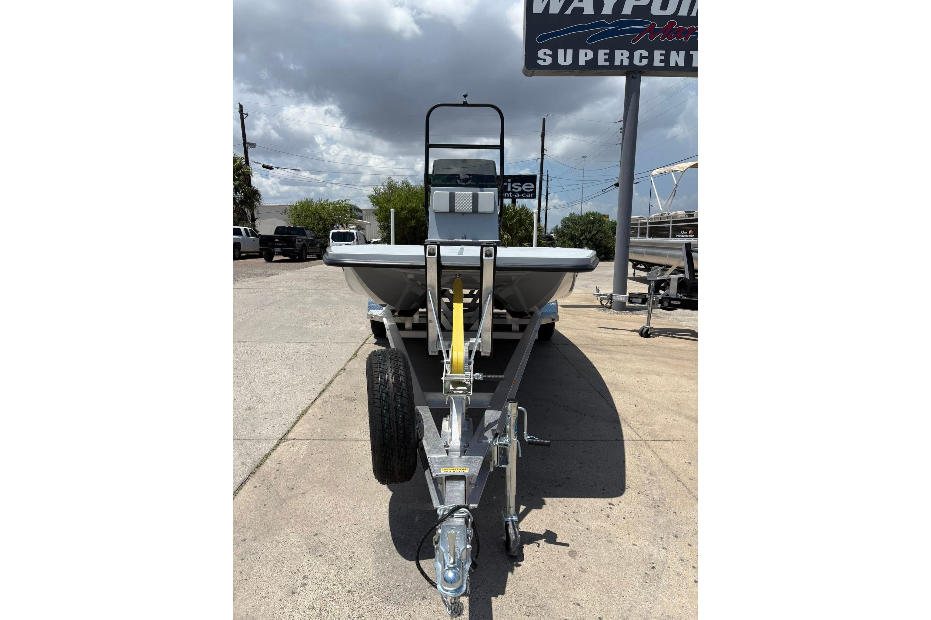 2026 Freedom Boats 23' Warrior on trailer at dealership under cloudy sky.