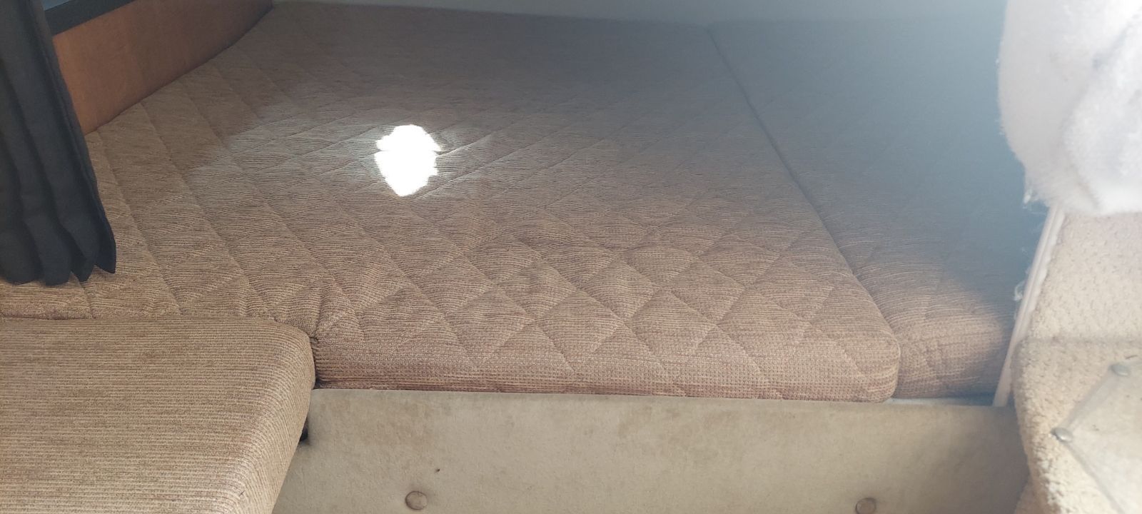 Interior of a 2004 Regal Commodore 2465 yacht with cushioned bed.