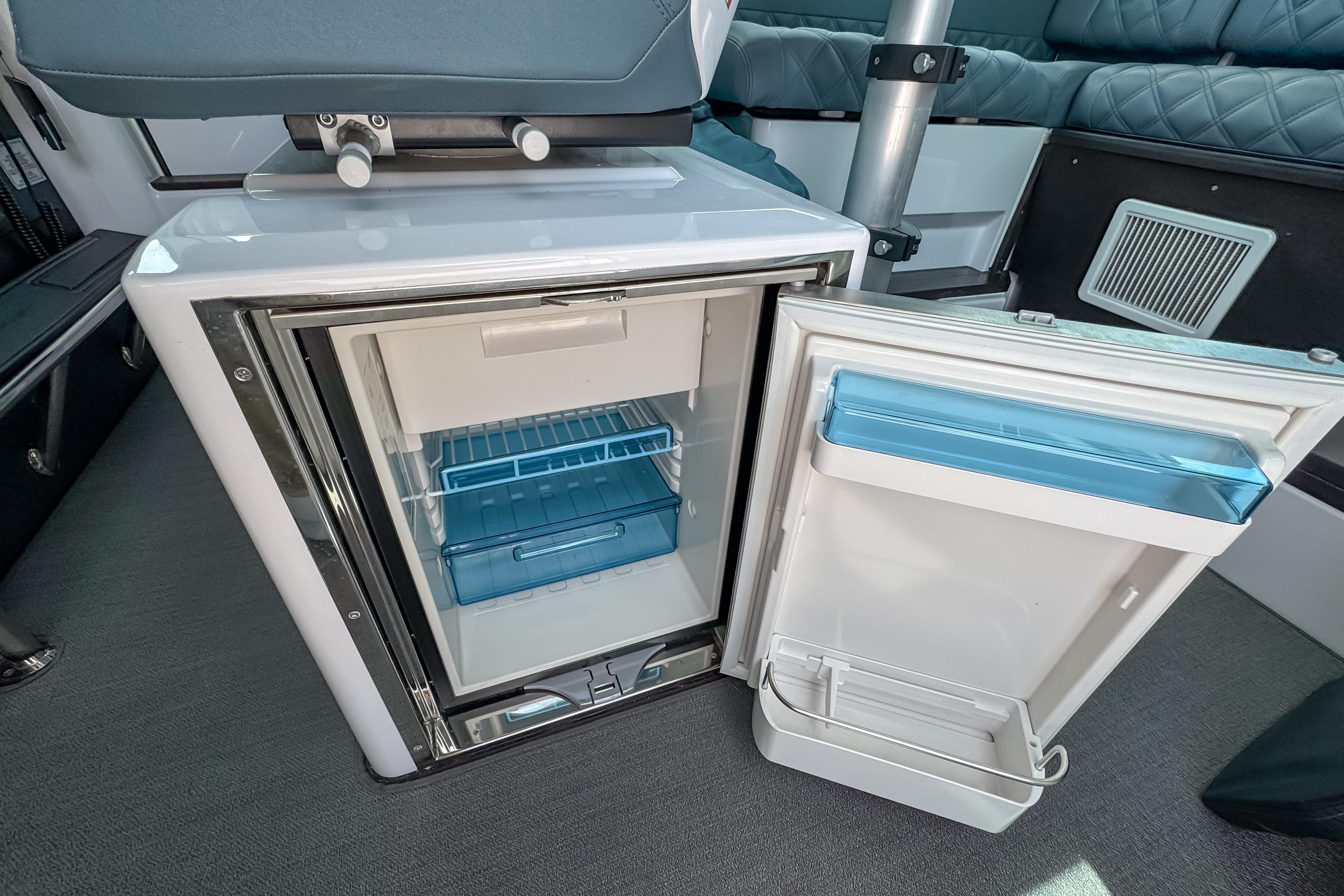 2023 Axopar 37 XC Cross Cabin interior fridge with open door, showcasing storage space.