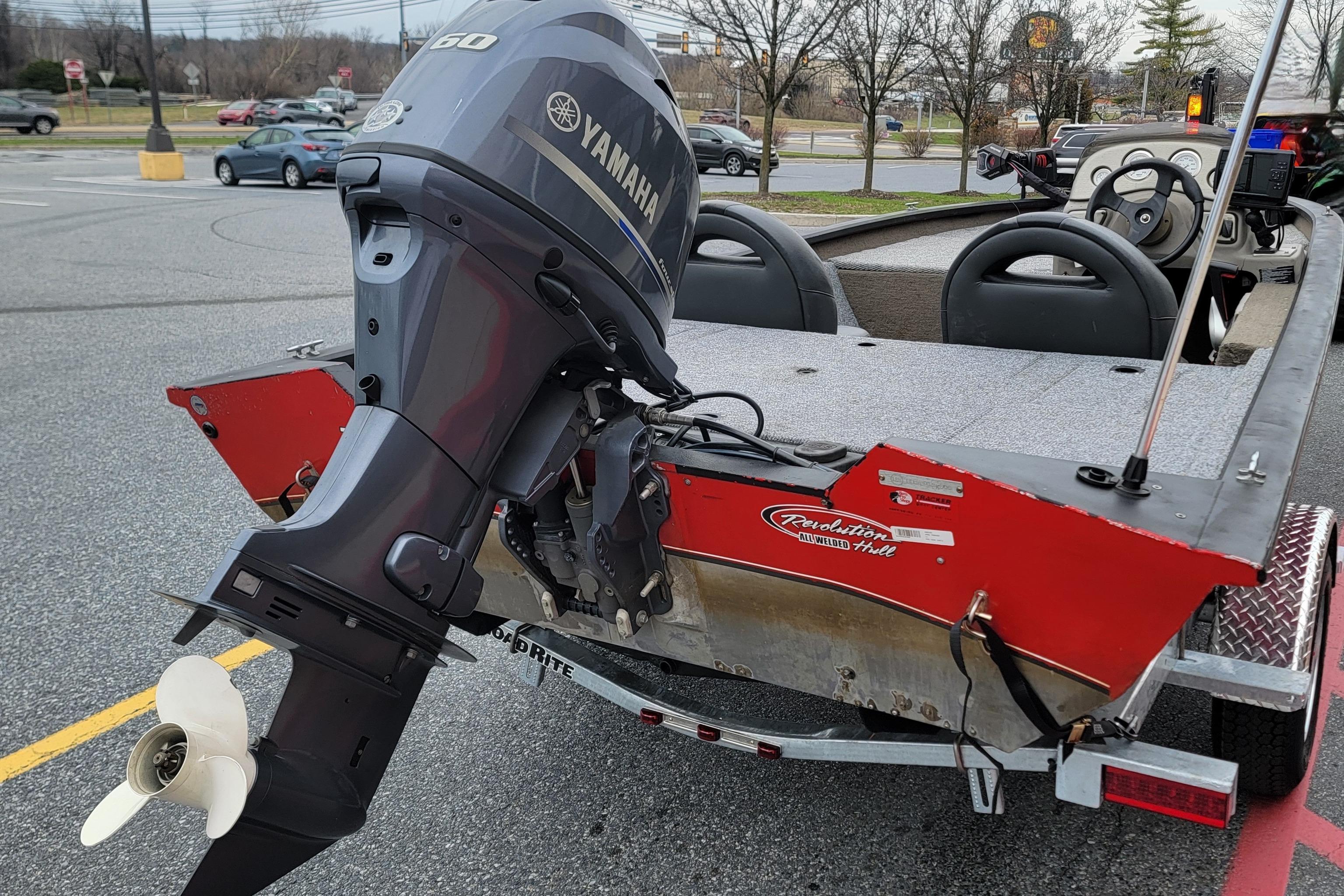 2006 Tracker Pro Team 190 TX boat with Yamaha outboard motor in parking lot.