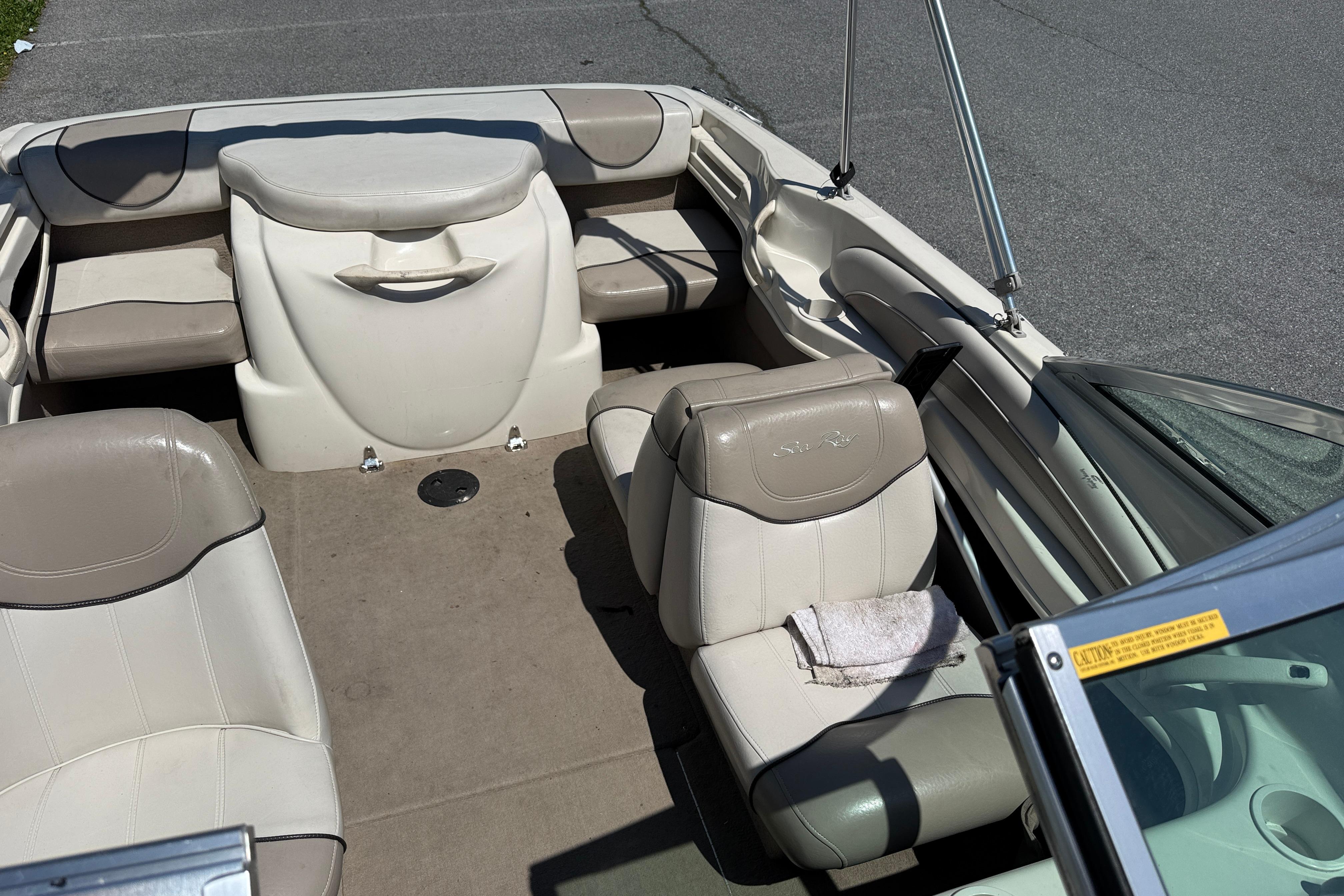 2003 Sea Ray 182 Bow Rider interior with beige seating and open layout.