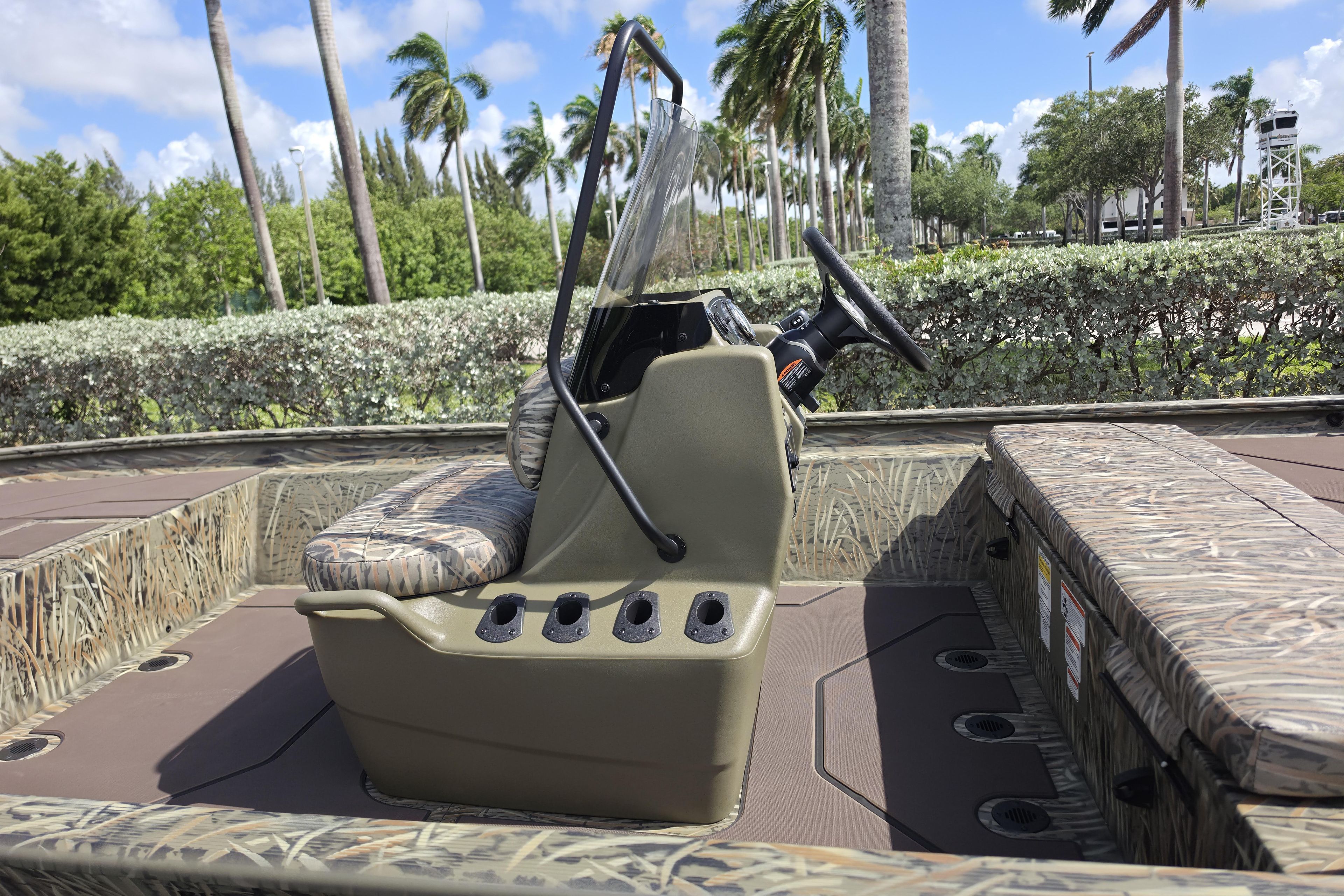 2026 Tracker Grizzly 1860 CC boat interior with camouflage seating and steering console.