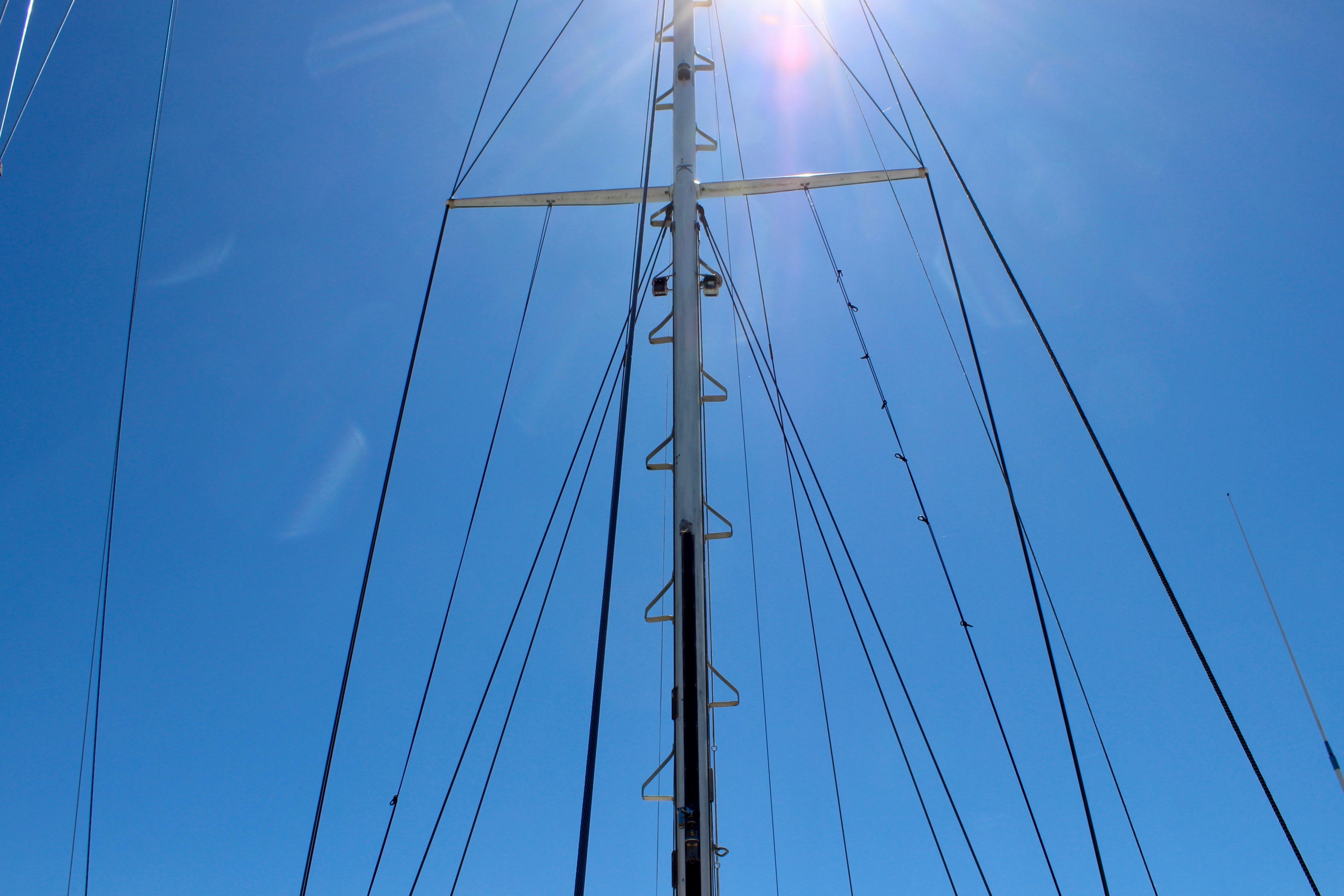 Mast of 1981 Kelly Peterson 46 sailboat against clear blue sky.