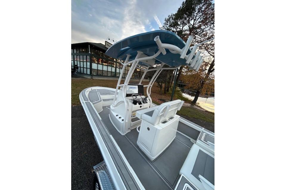 2025 Mako 24 APEX boat with modern console and seating, parked outdoors.