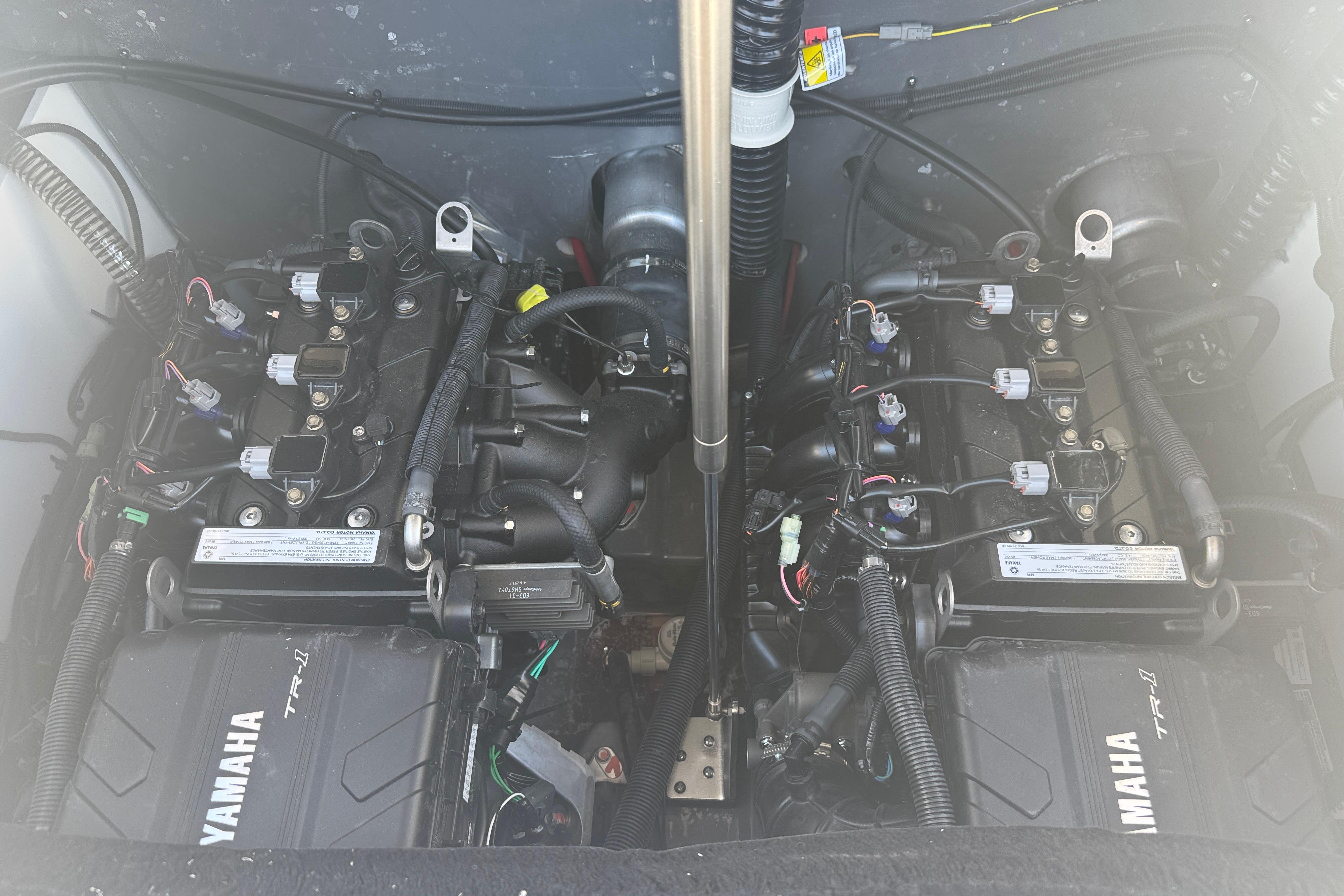 Engine compartment of 2026 Yamaha Boats 220 FSH Sport, showcasing dual Yamaha TR-1 engines.