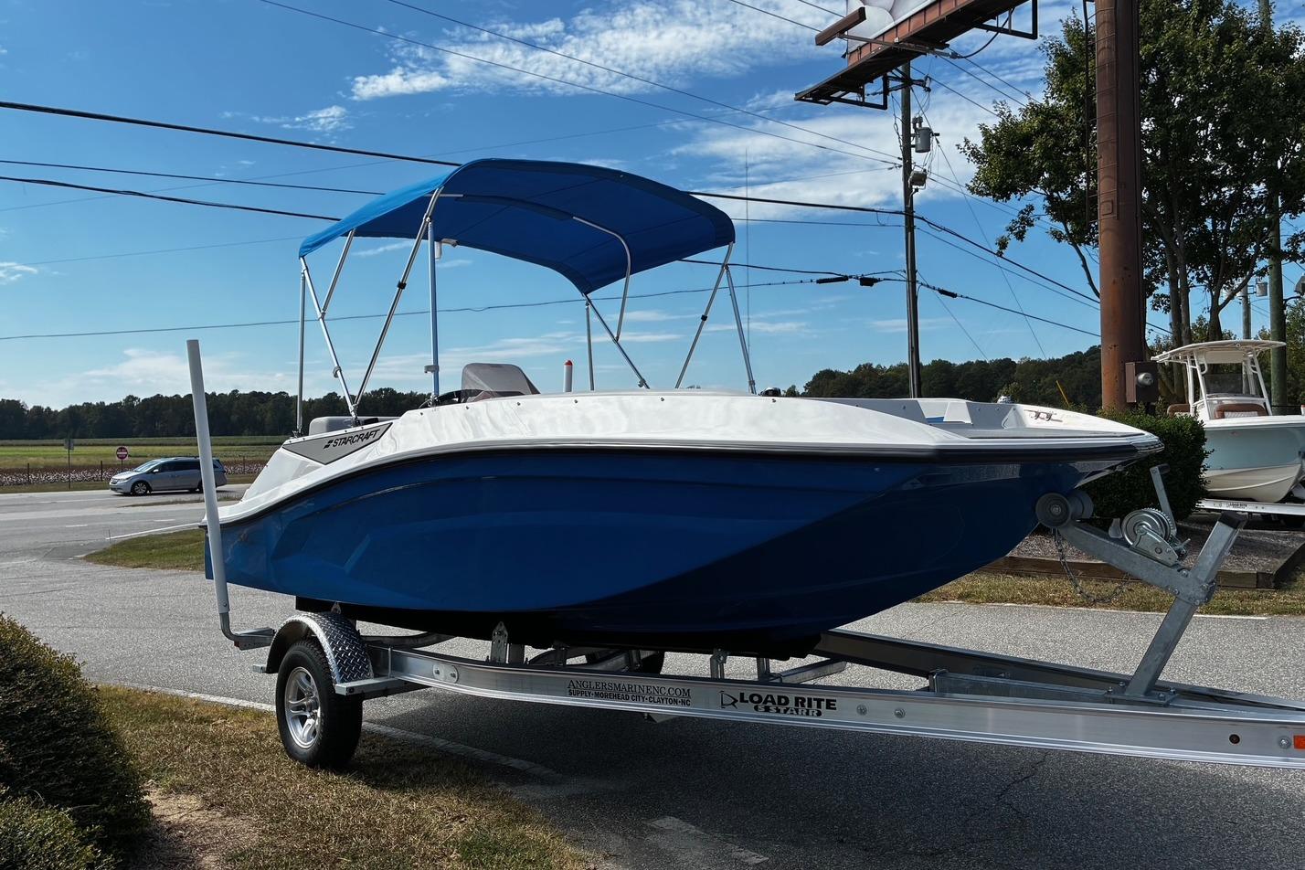 2026 Starcraft SV 16 OB boat with blue hull and canopy on trailer.