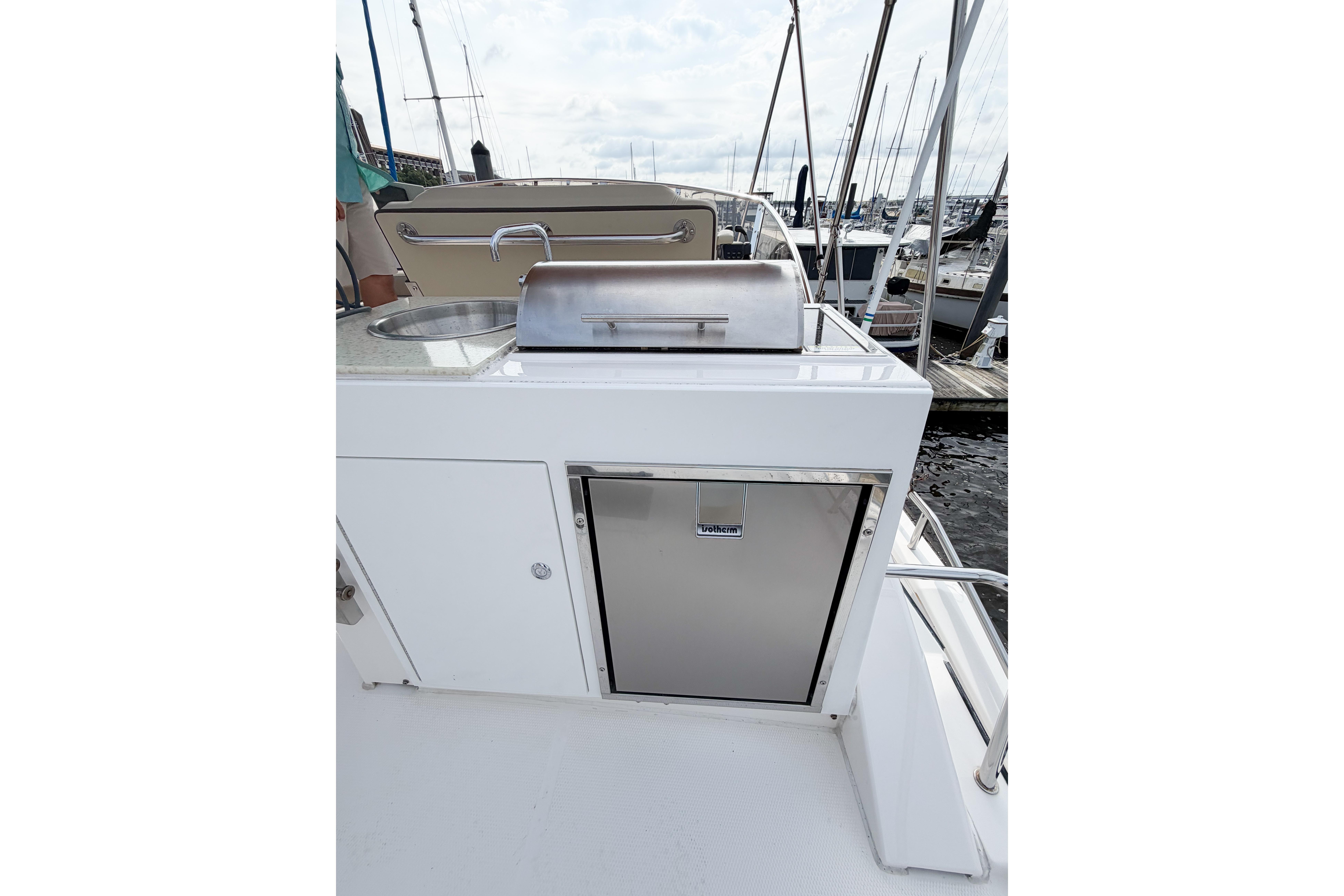 Outdoor kitchen on 2022 Ranger Tugs R-43 CB yacht with grill and sink.