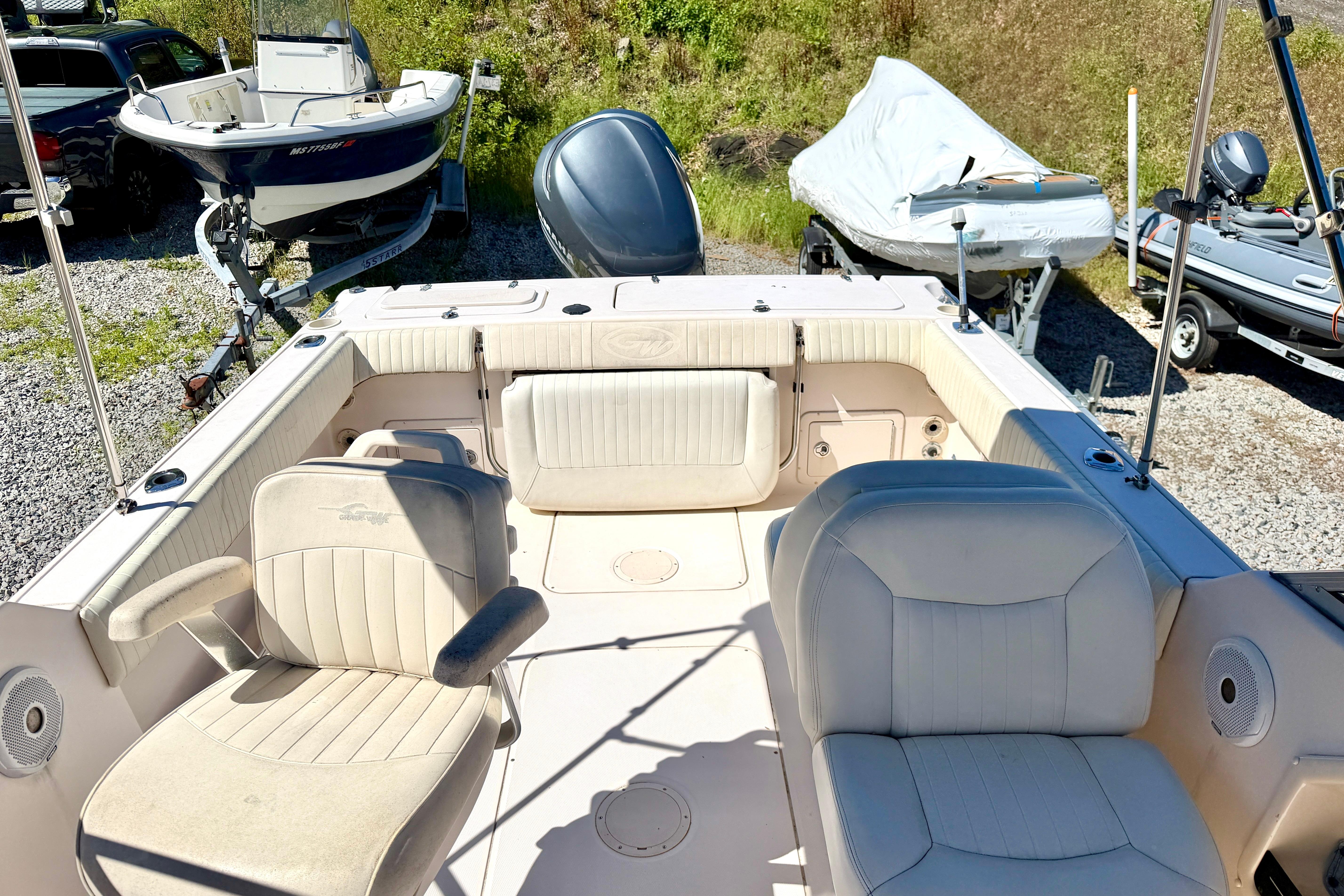 2005 Grady-White Freedom 225 boat interior with seating, parked on gravel lot.