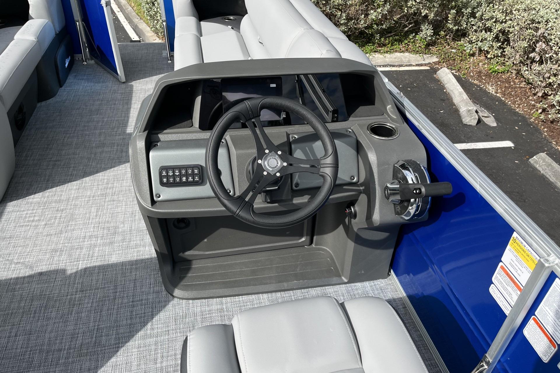 2026 Sun Tracker Party Barge 20 DLX helm with steering wheel and controls.