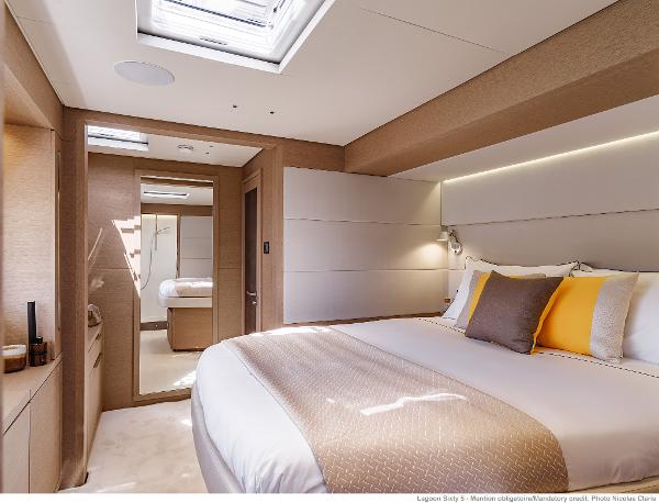 Luxurious bedroom interior of 2025 Lagoon SIXTY 5 yacht, featuring elegant design and modern amenities.
