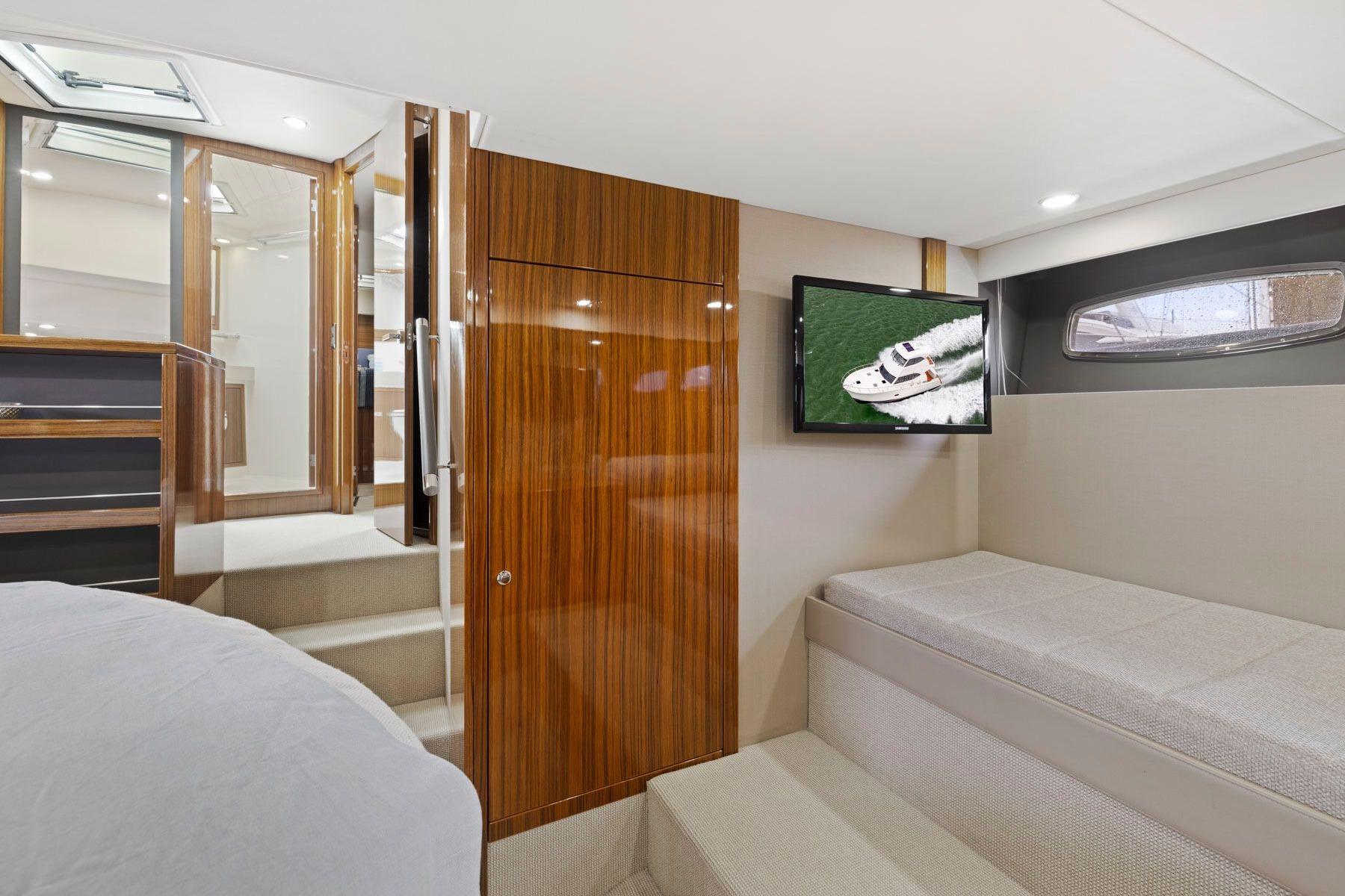Luxurious interior of 2014 Maritimo M50 yacht with wood paneling and TV.