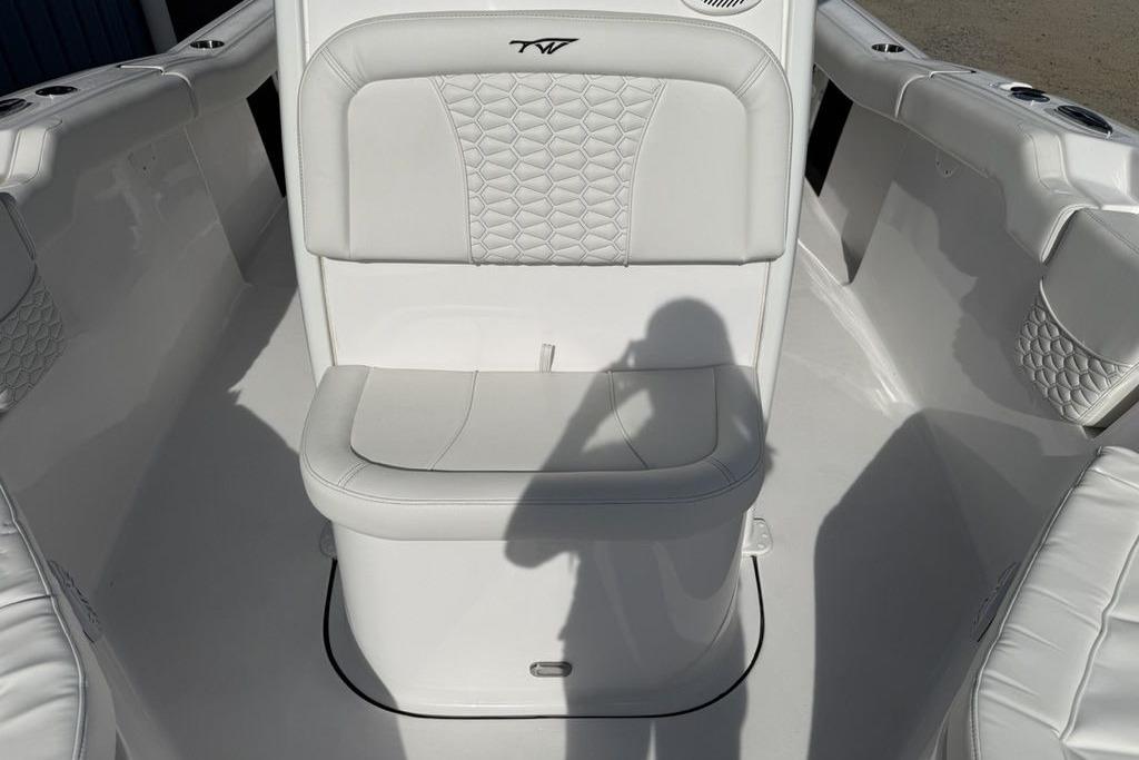2026 Tidewater 232 LXF boat interior with white cushioned seating and elegant design.