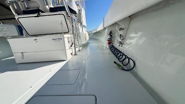 2005 Contender 36 Open boat deck with storage and coiled hose.