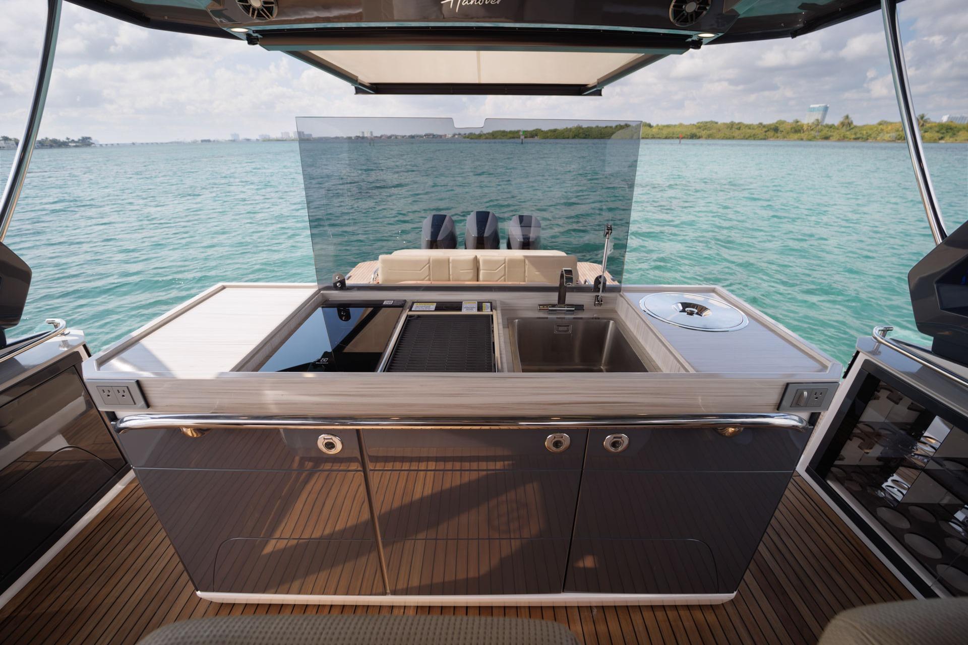 Luxury Hanover 447 yacht kitchen with sleek design, overlooking serene blue waters, 2026 model.