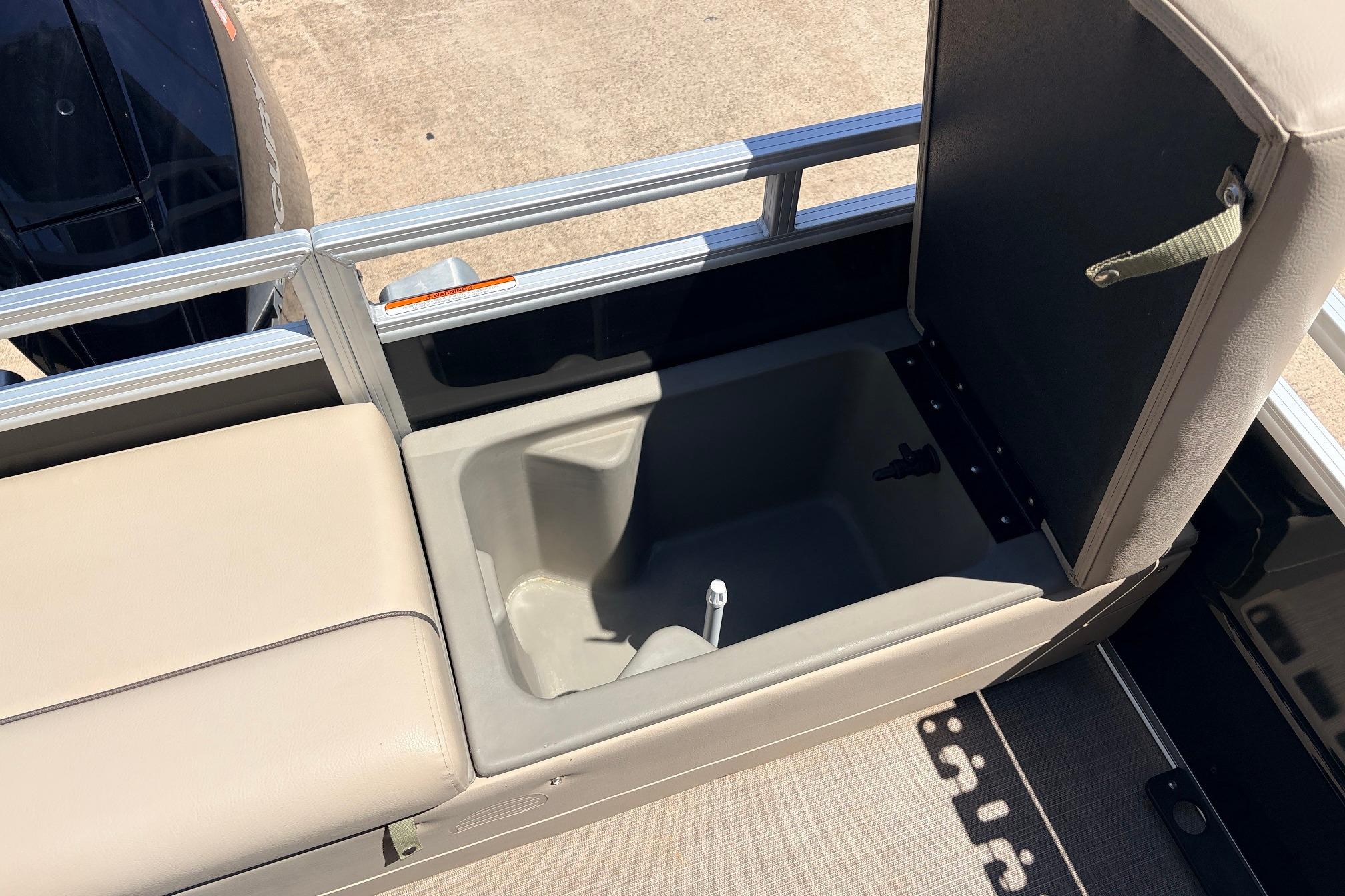 2024 Sun Tracker SportFish 22 XP3 boat storage compartment with open lid, showcasing interior space.