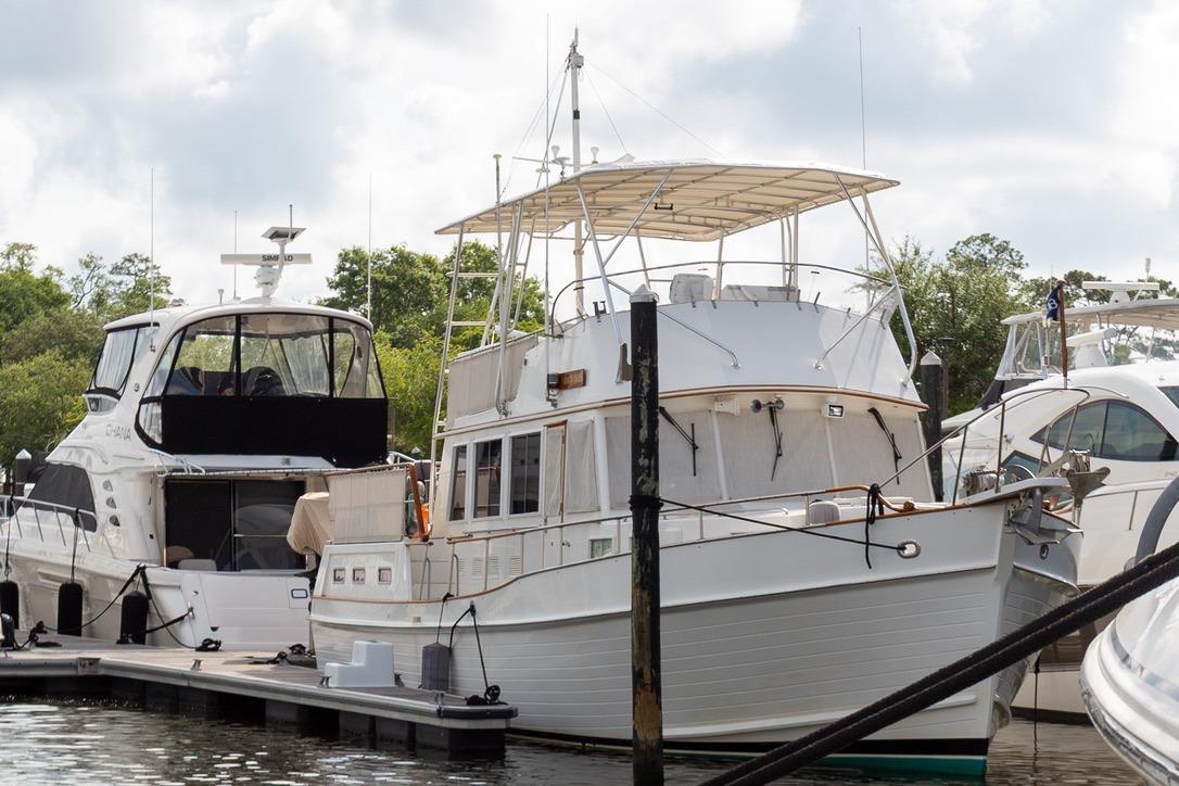1993 Grand Banks 46 Motoryacht docked at marina, surrounded by other boats.