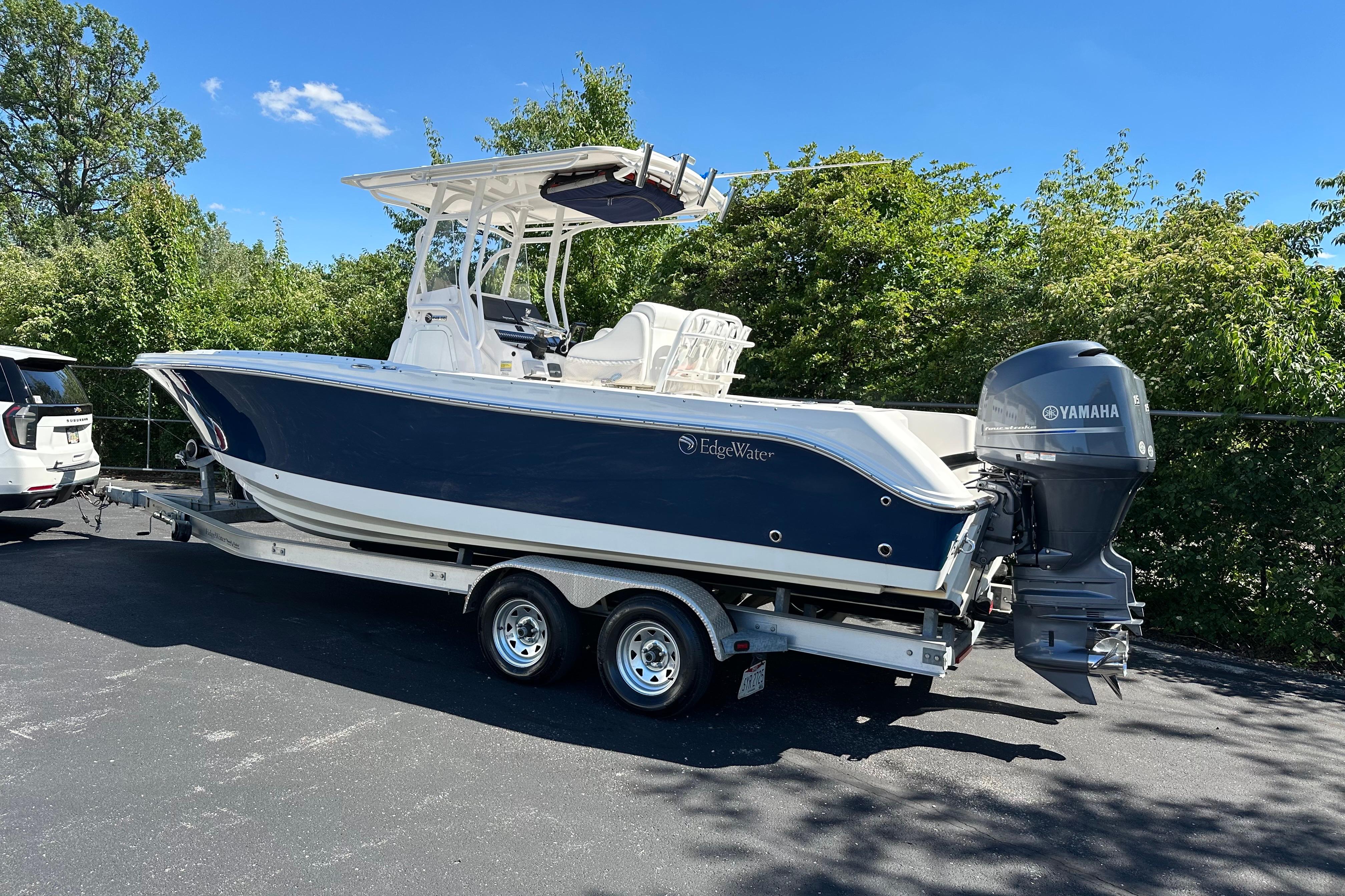 2015 Edgewater 245CC boat on trailer with Yamaha outboard motor, parked outdoors.