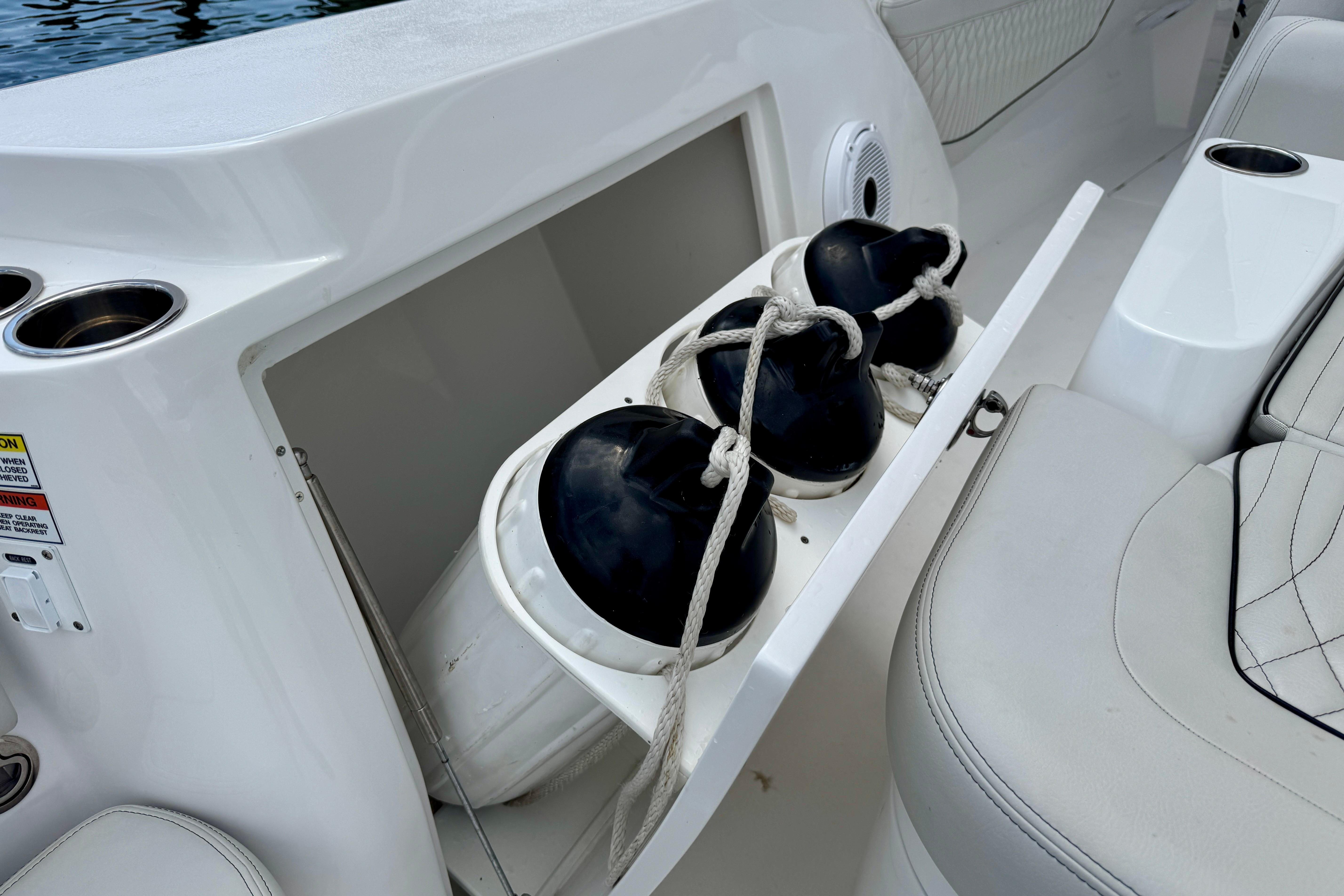 Storage compartment with fenders on a 2024 Intrepid 427 Nomad SE boat.