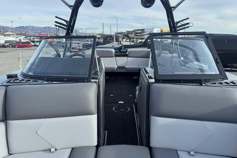 2026 Moomba Tykon boat interior with gray seating and open windshield.