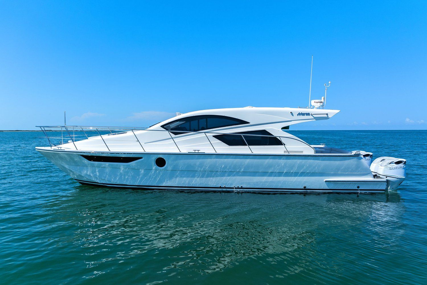 A sleek, modern catamaran with a curved design on calm water.