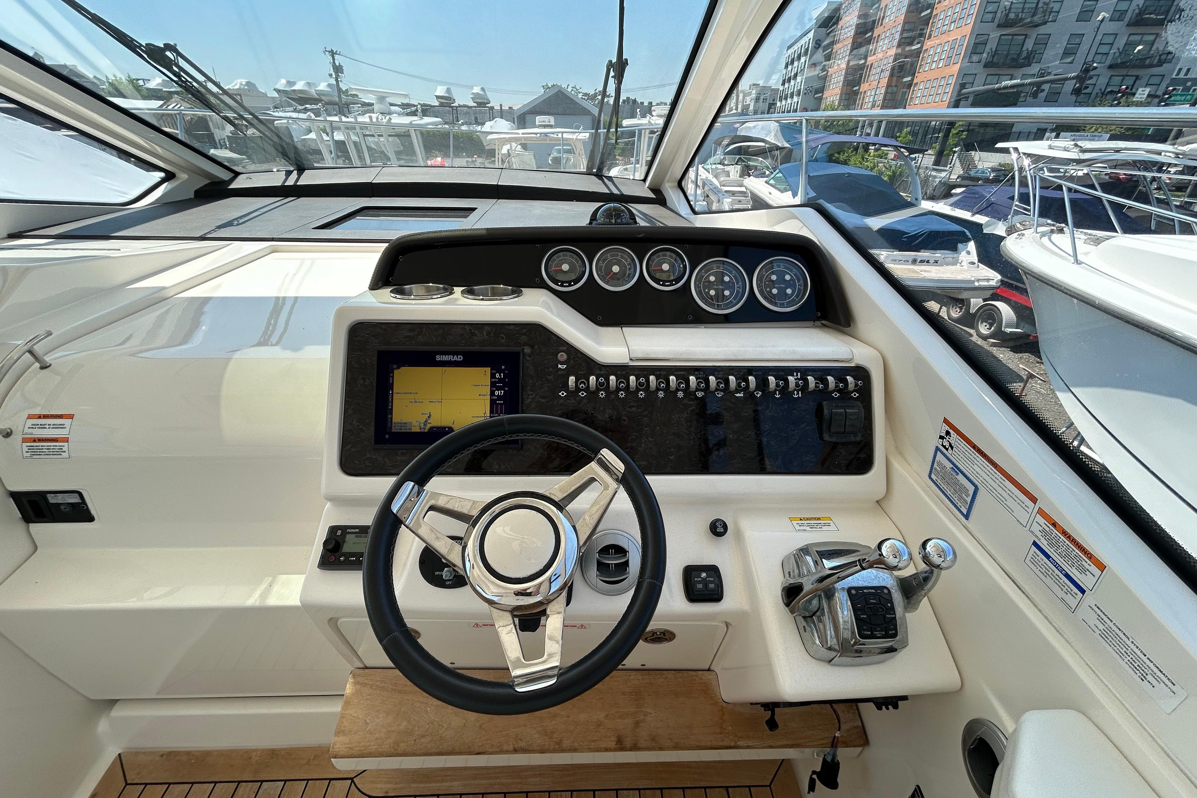 Cockpit of 2019 Sea Ray Sundancer 350 with steering wheel and navigation controls.