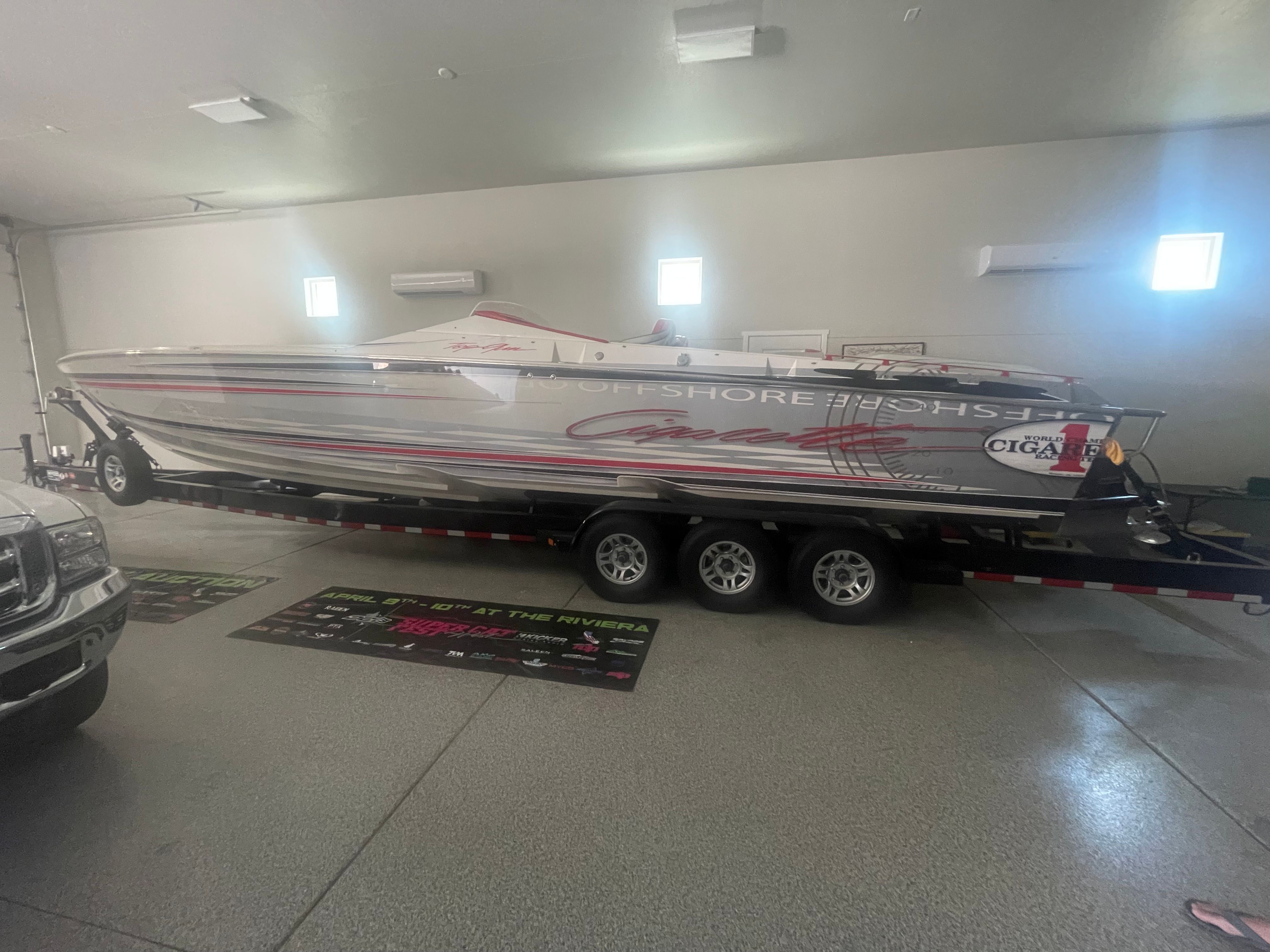 2004 Cigarette 38' Top Gun boat in garage on trailer.