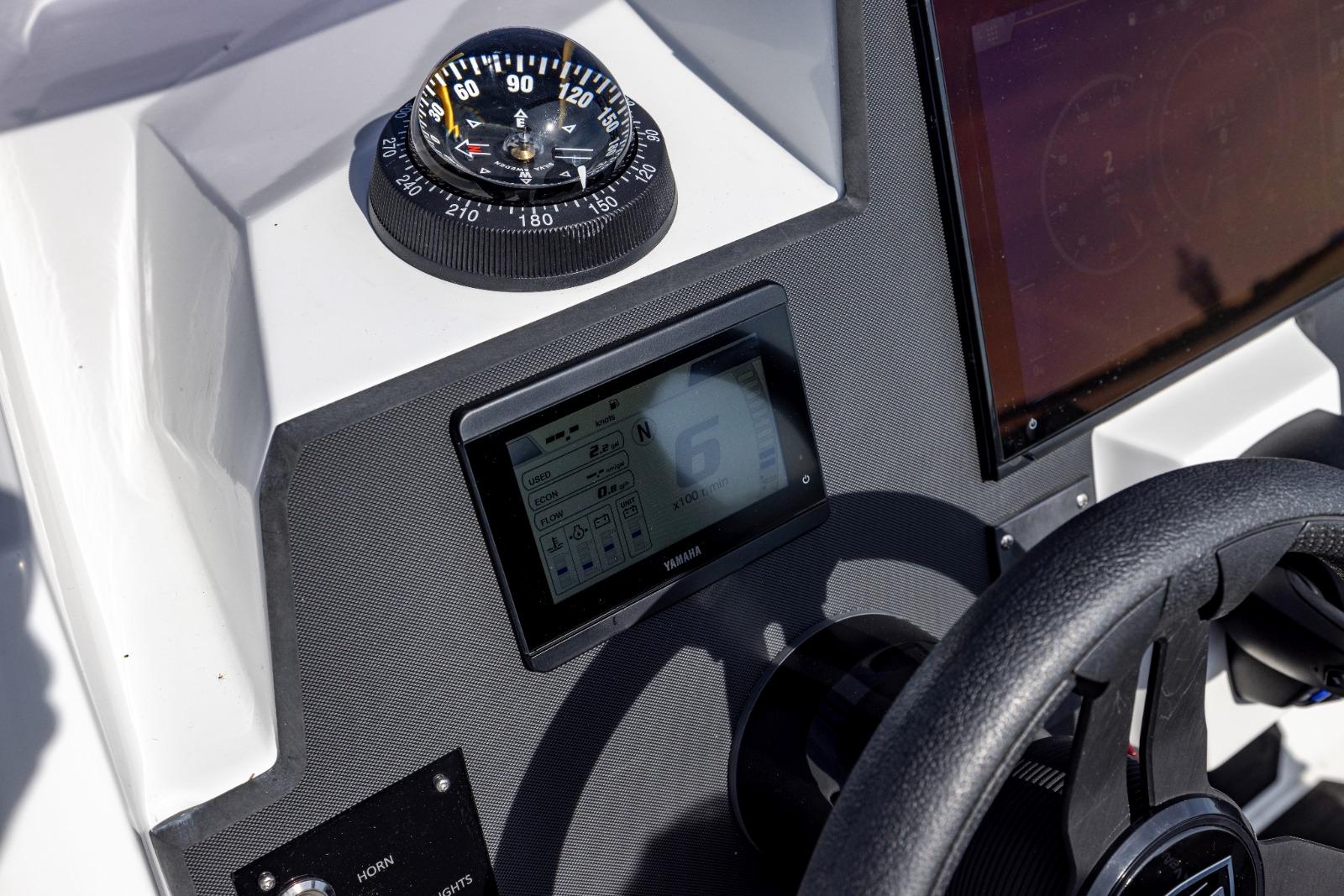 Control panel of Iron 707 boat, featuring compass and digital display, 2022 model.