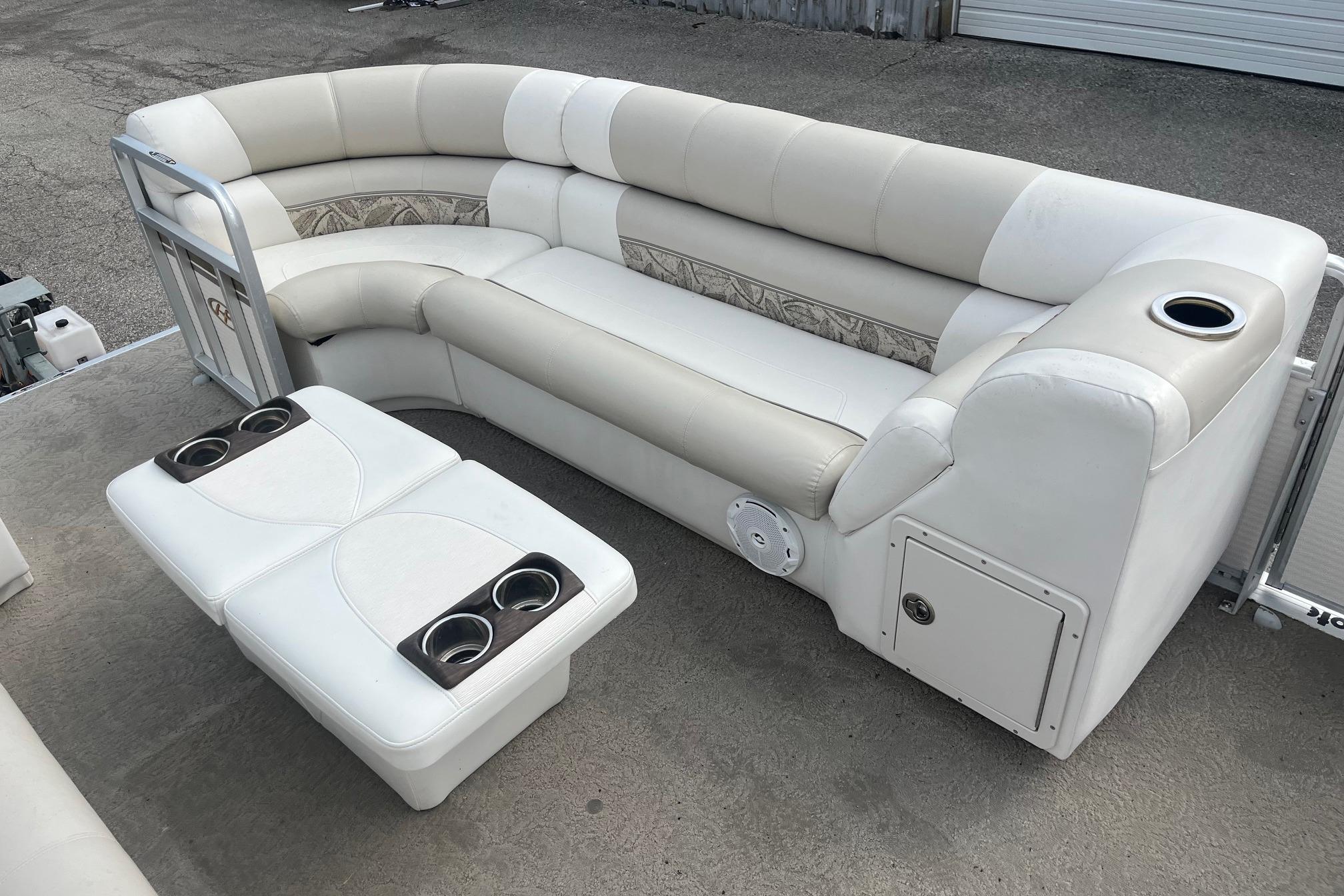 2008 Harris Super Sunliner 240 pontoon boat interior with white seating and cup holders.