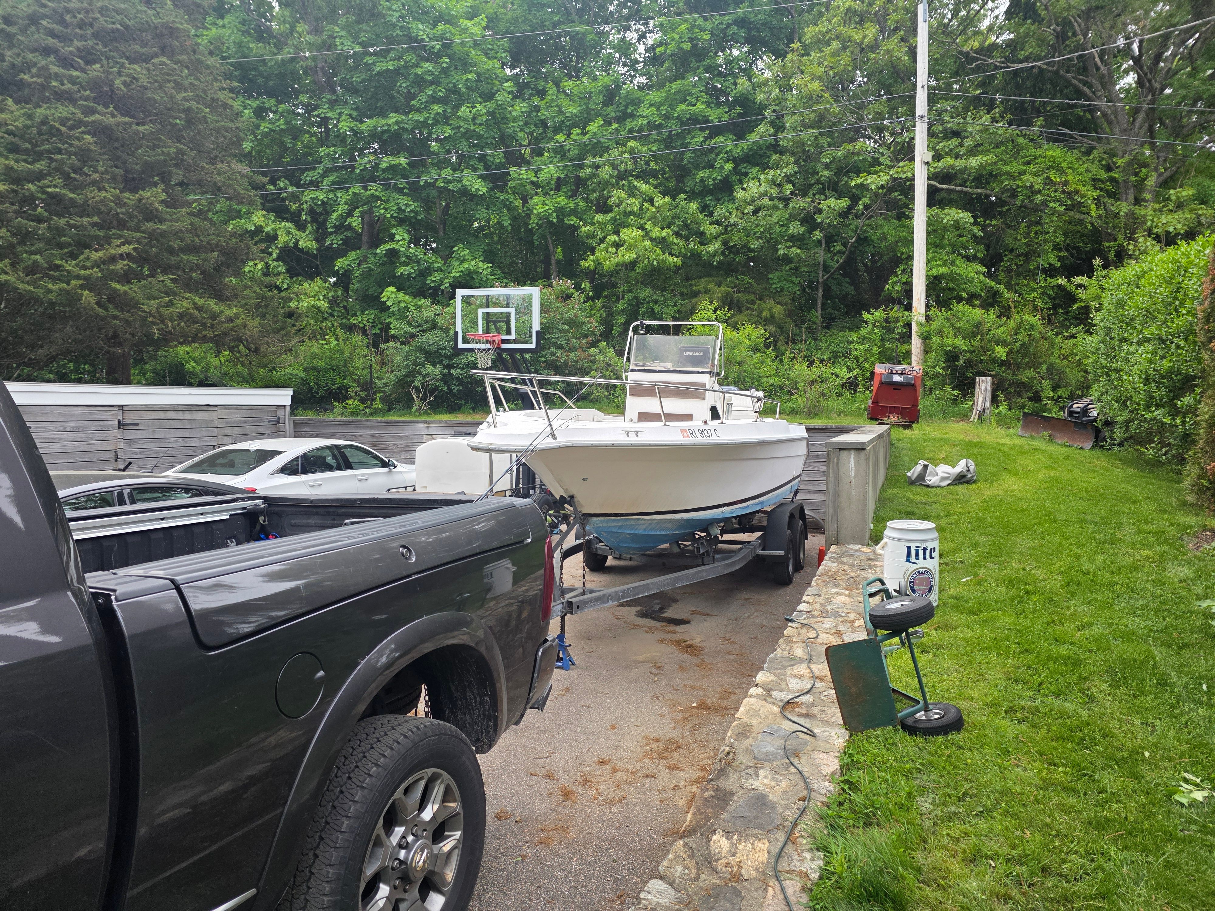 1989 Sea Ray Laguna boat on trailer in backyard.