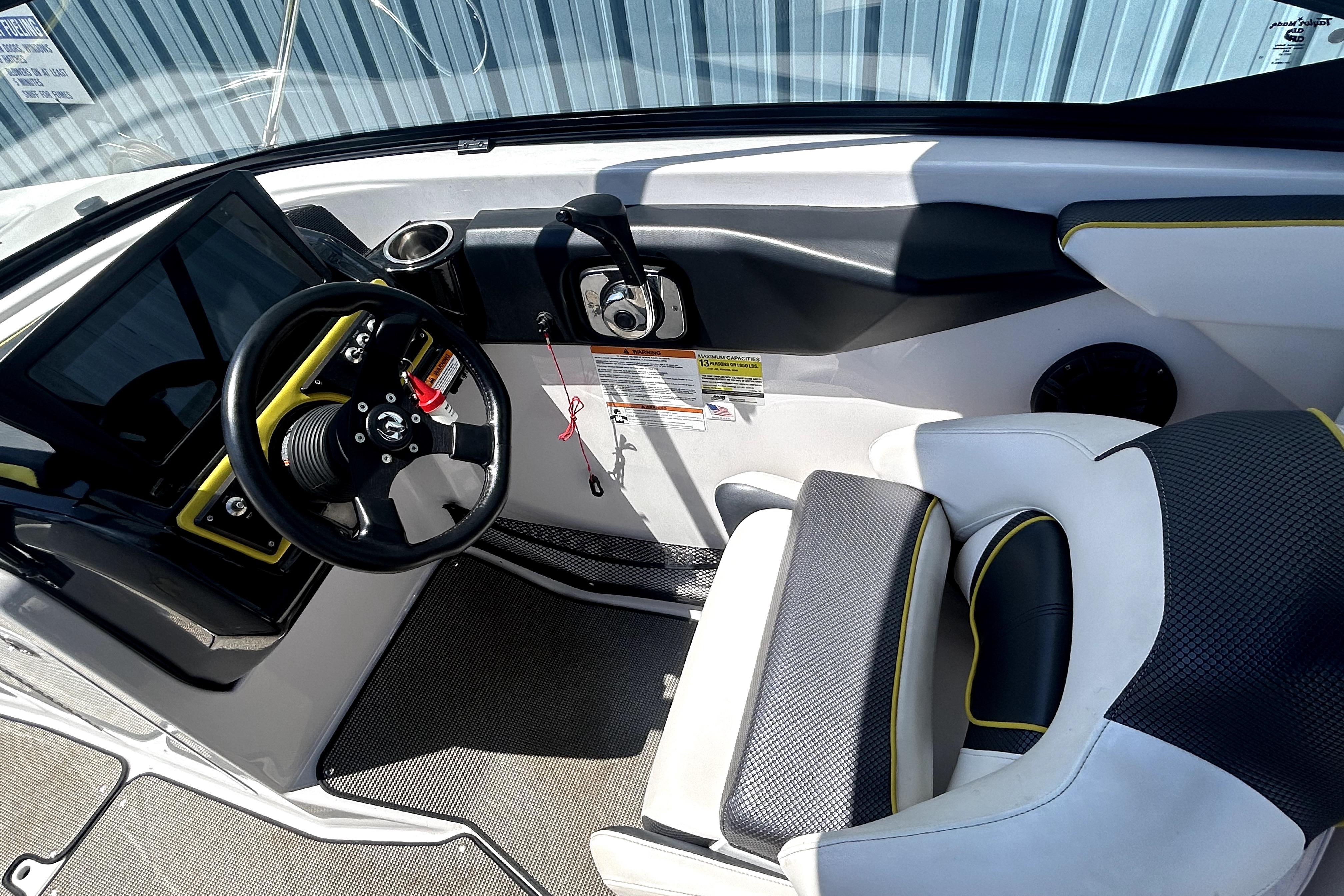 2017 Scarab 255 H.O. Impulse boat interior with steering wheel and seating.