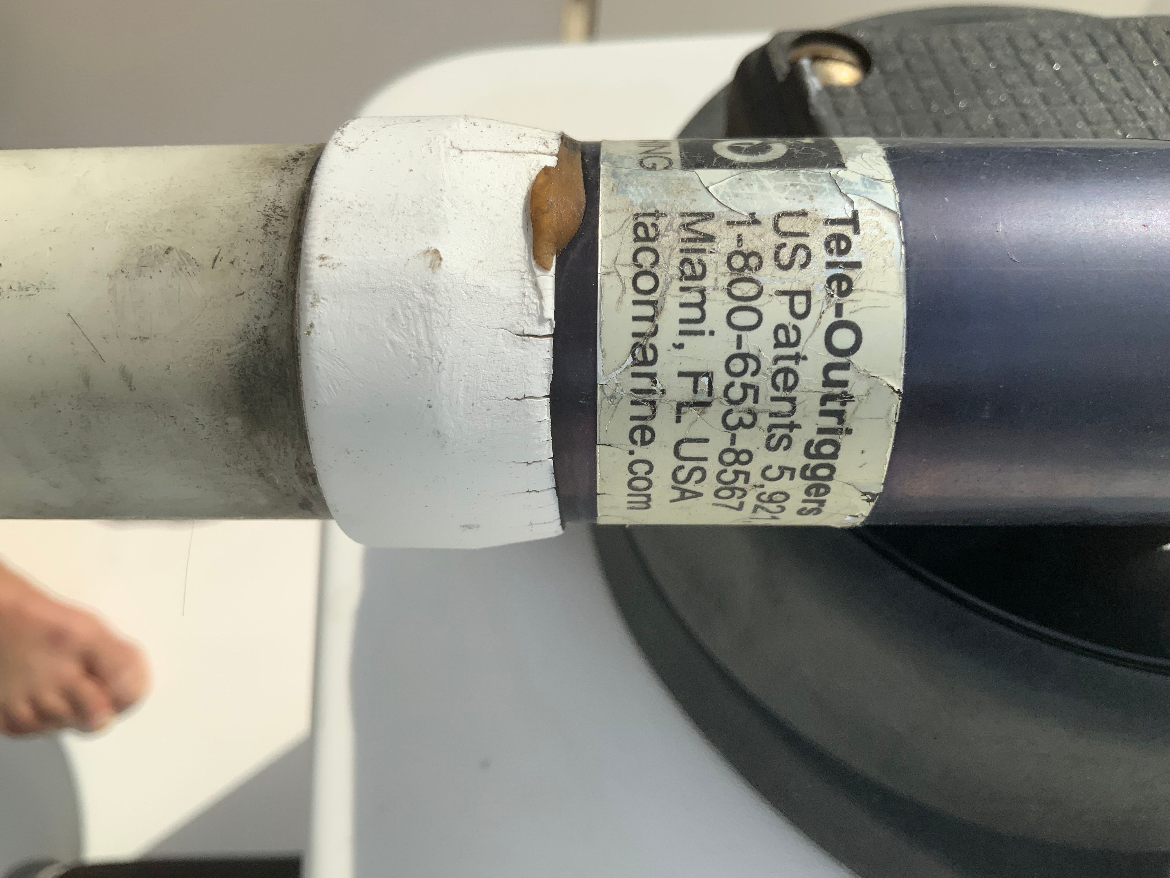 Close-up of a boat part with a label showing contact information and patent numbers.