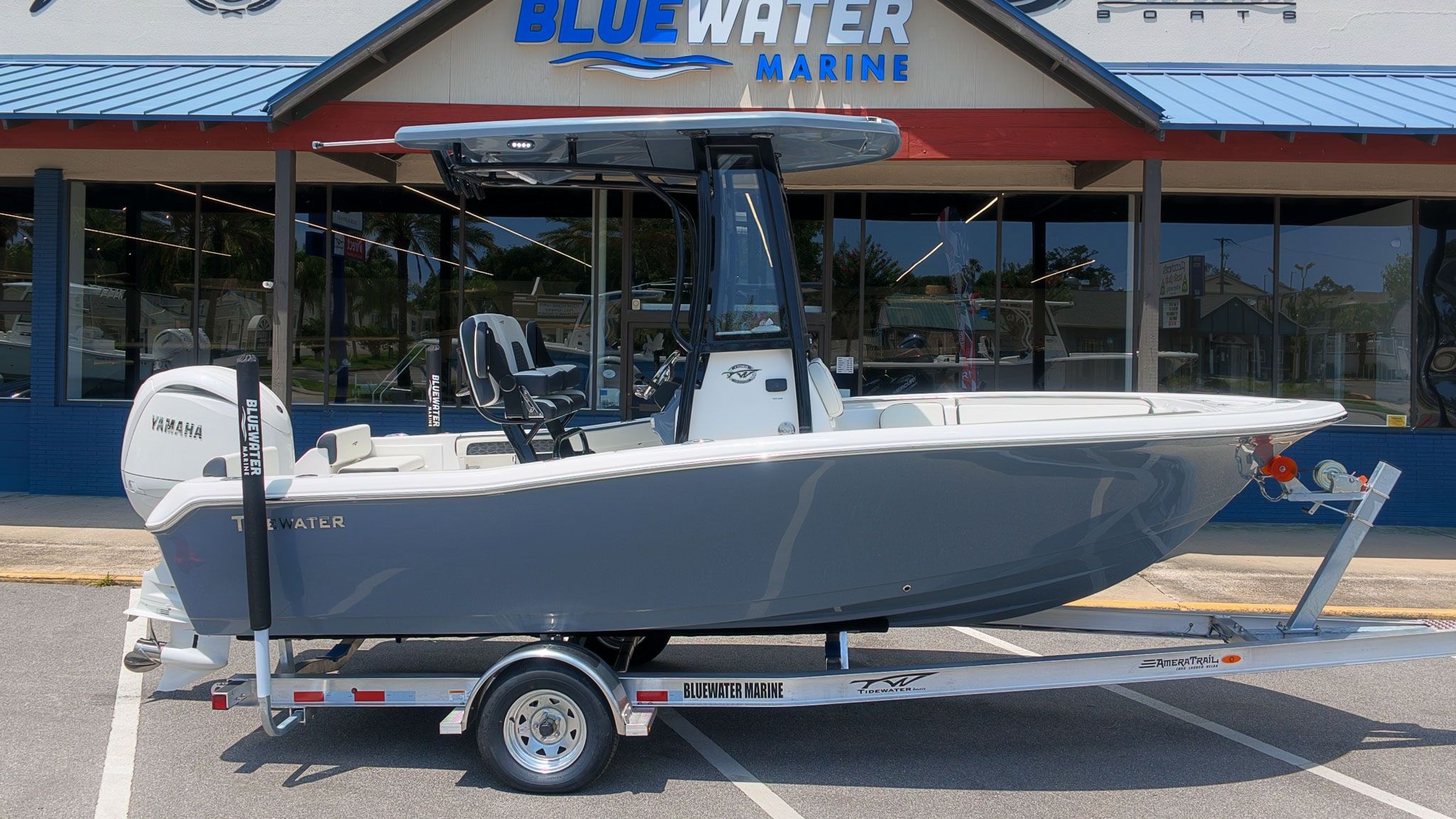 Tidewater 198 CC Adventure from 2027 on a trailer in front of a marine store.