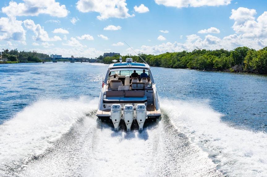 2019 Sea Ray SLX 400 Outboard cruising on a sunny day, creating a wake in the water.