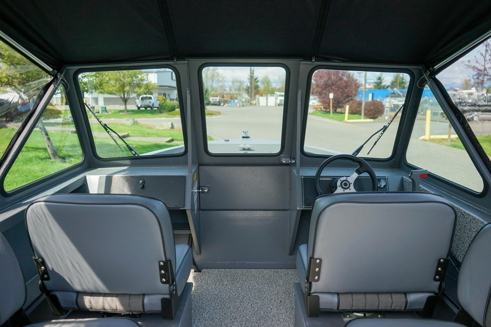 Interior view of 2026 Alumaweld Talon 18 boat, featuring dual seats and steering console.