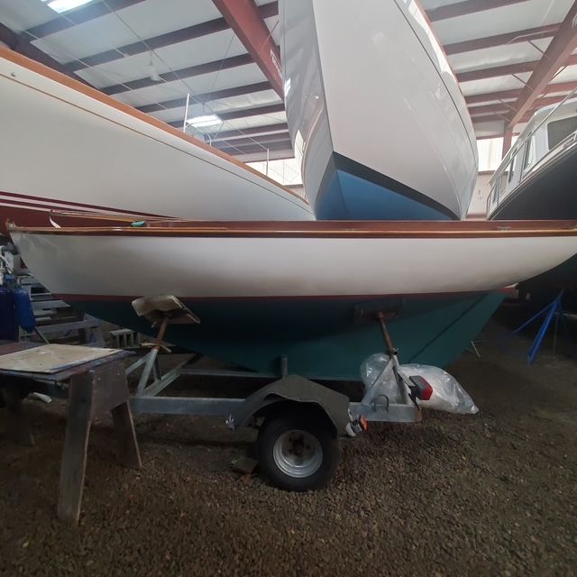 2003 Herreshoff 12.5 sailboat in a boatyard storage.