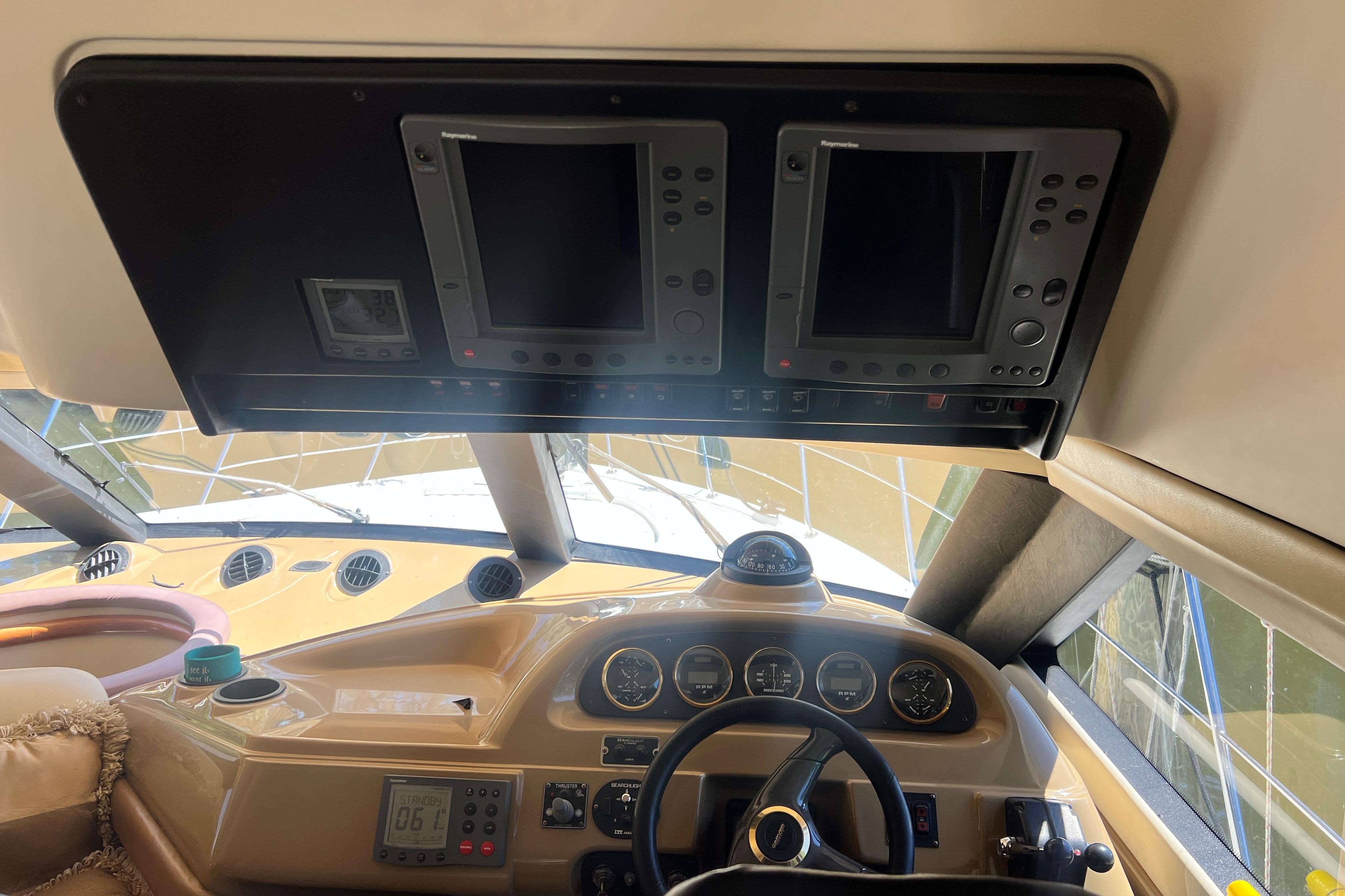 Interior helm of 2003 Carver 450 Voyager Pilothouse with navigation instruments.