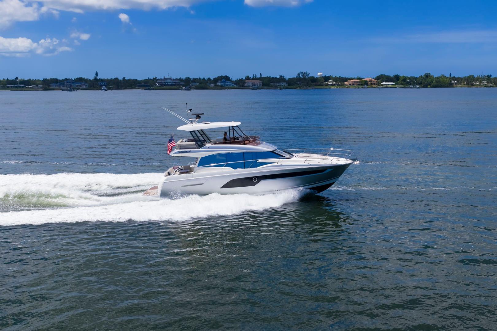 2022 Prestige 520 yacht cruising on a sunny day, showcasing sleek design and performance.