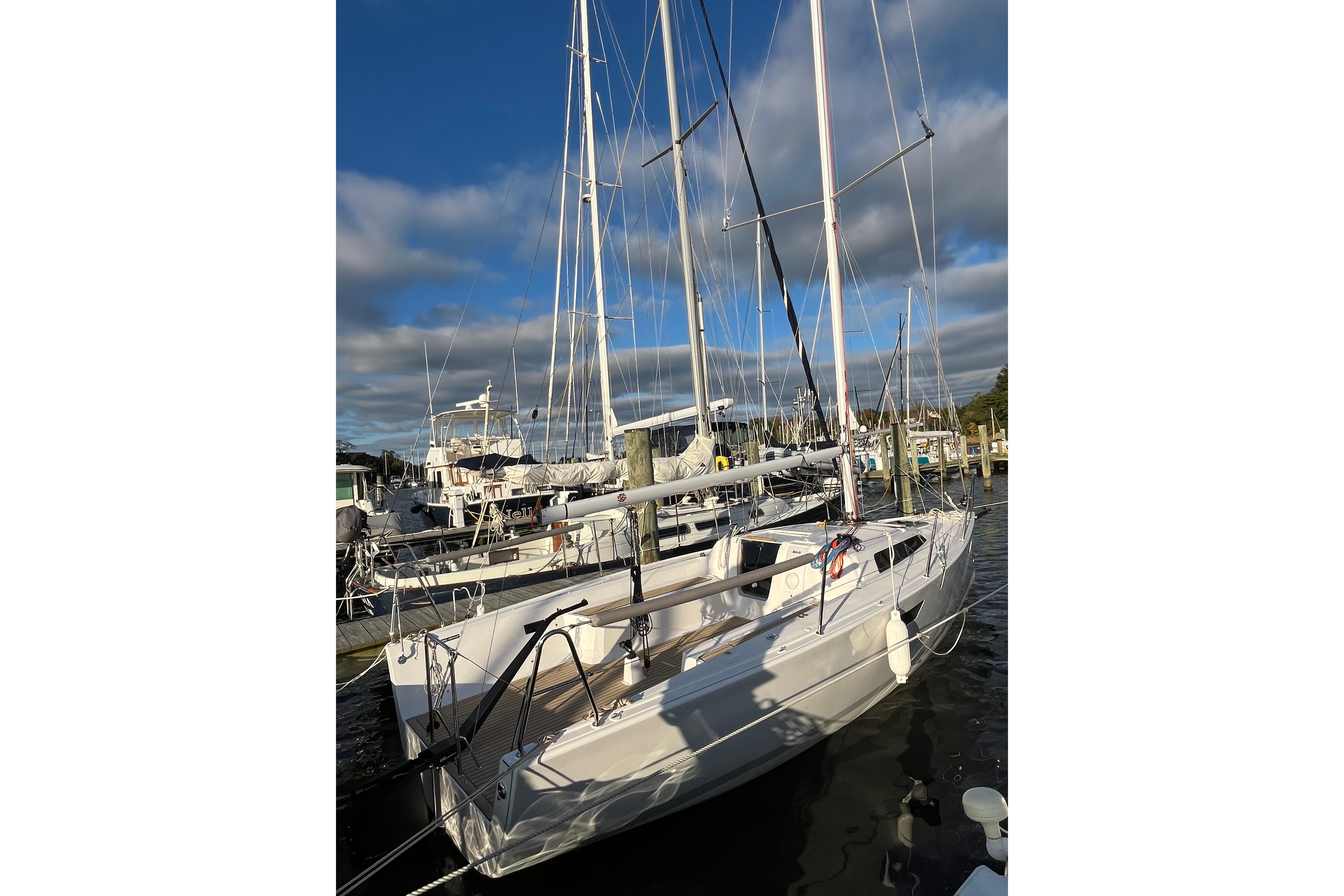2025 Zonda Yachts Z28 sailboat docked at marina under blue sky.