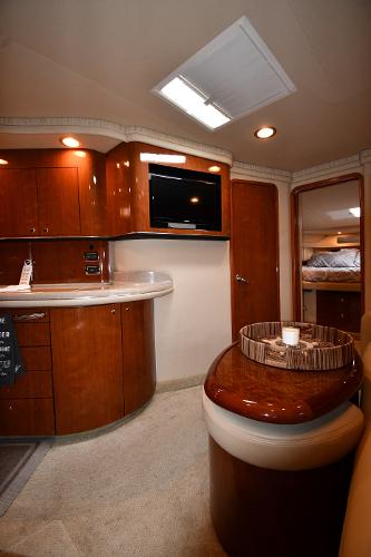 Luxurious interior of 2003 Sea Ray 460 Sundancer yacht with wood cabinetry and modern amenities.