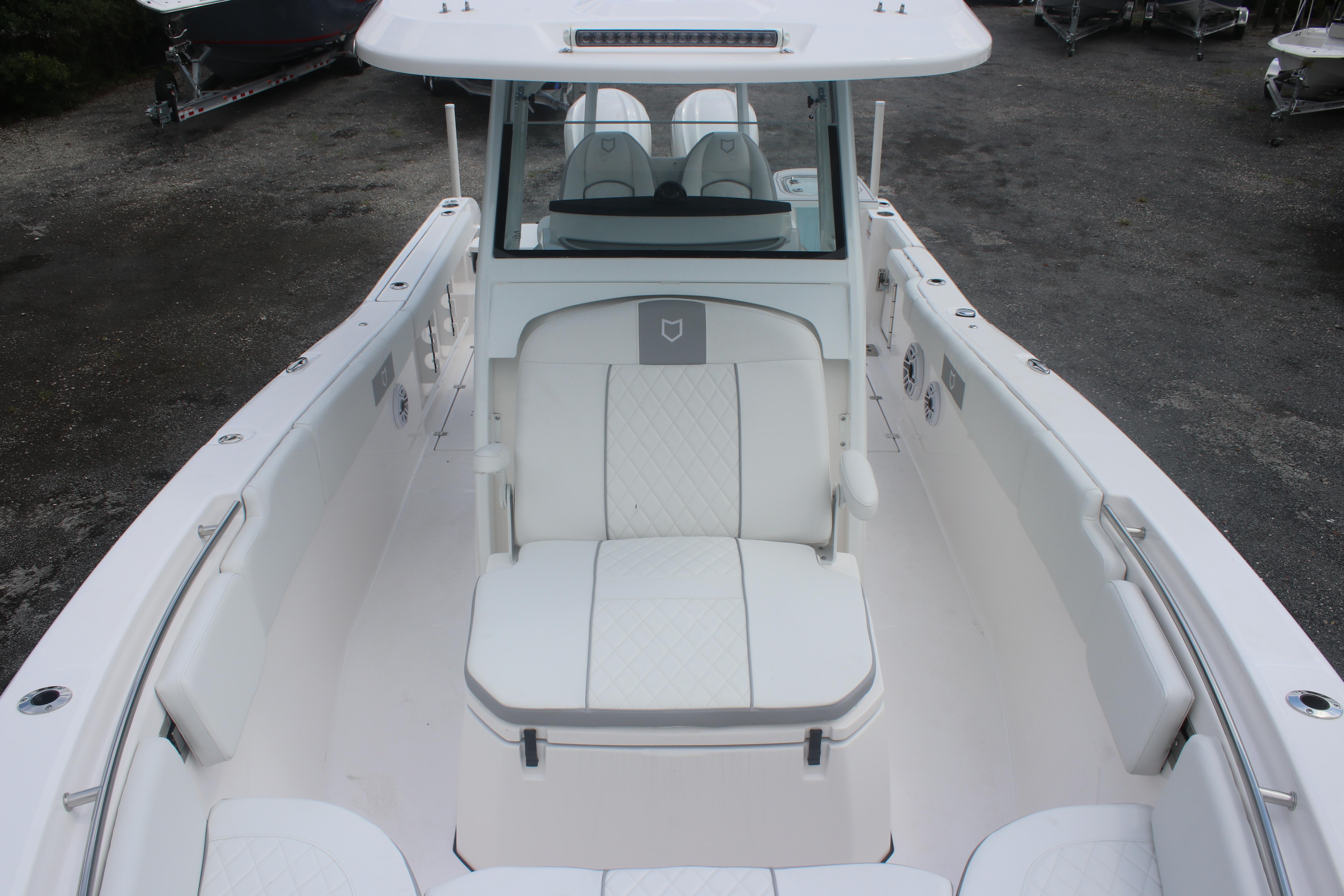 2026 Sea Fox 288 Commander boat interior with white seating and console.