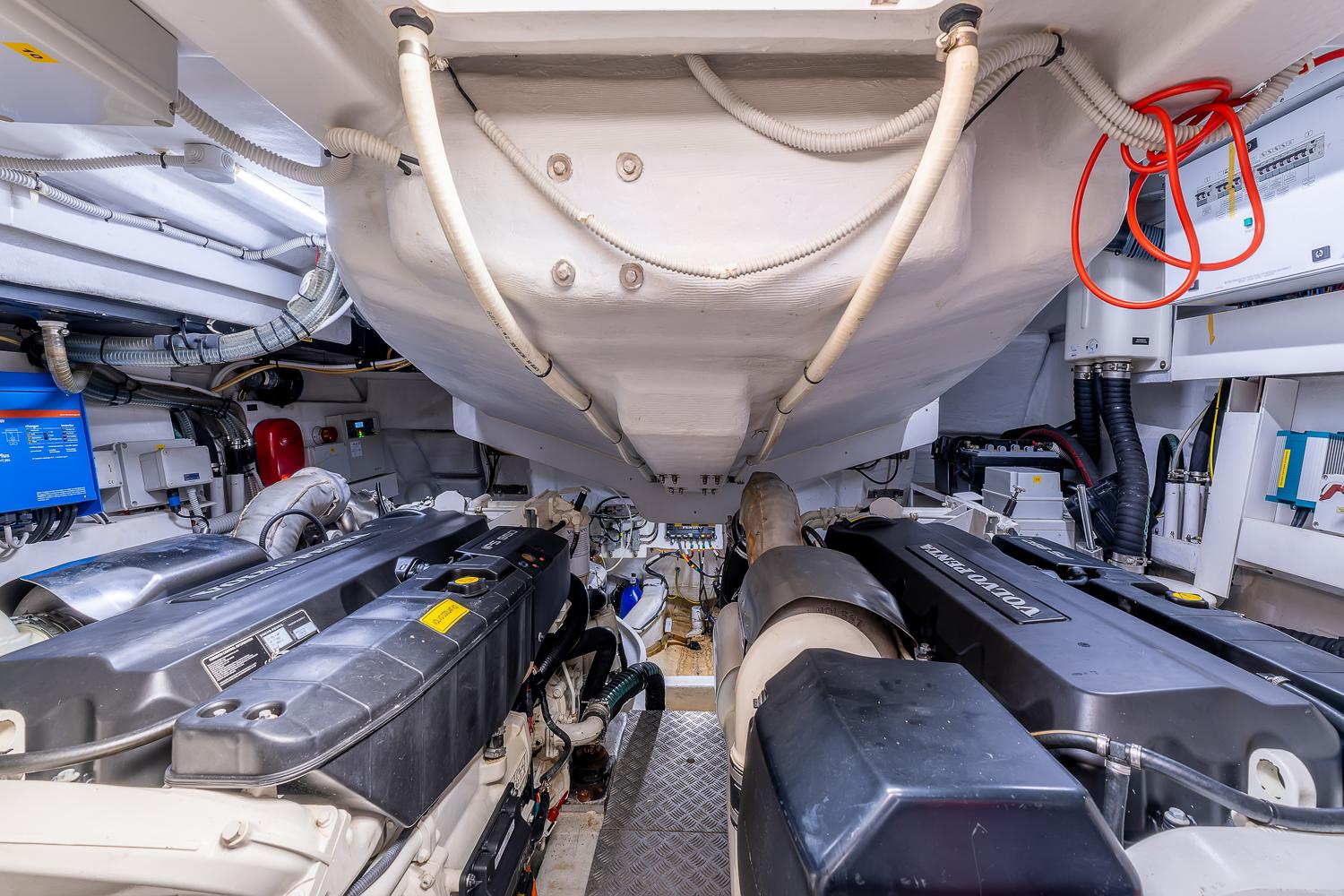 Engine room of a 2017 Pershing 5x yacht, showcasing dual engines and mechanical components.