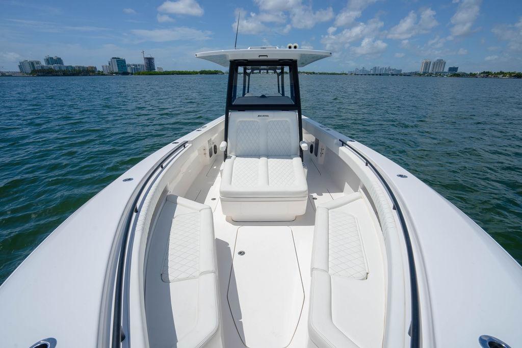 2027 Reef Runner 340 boat on water, featuring spacious seating and modern design.