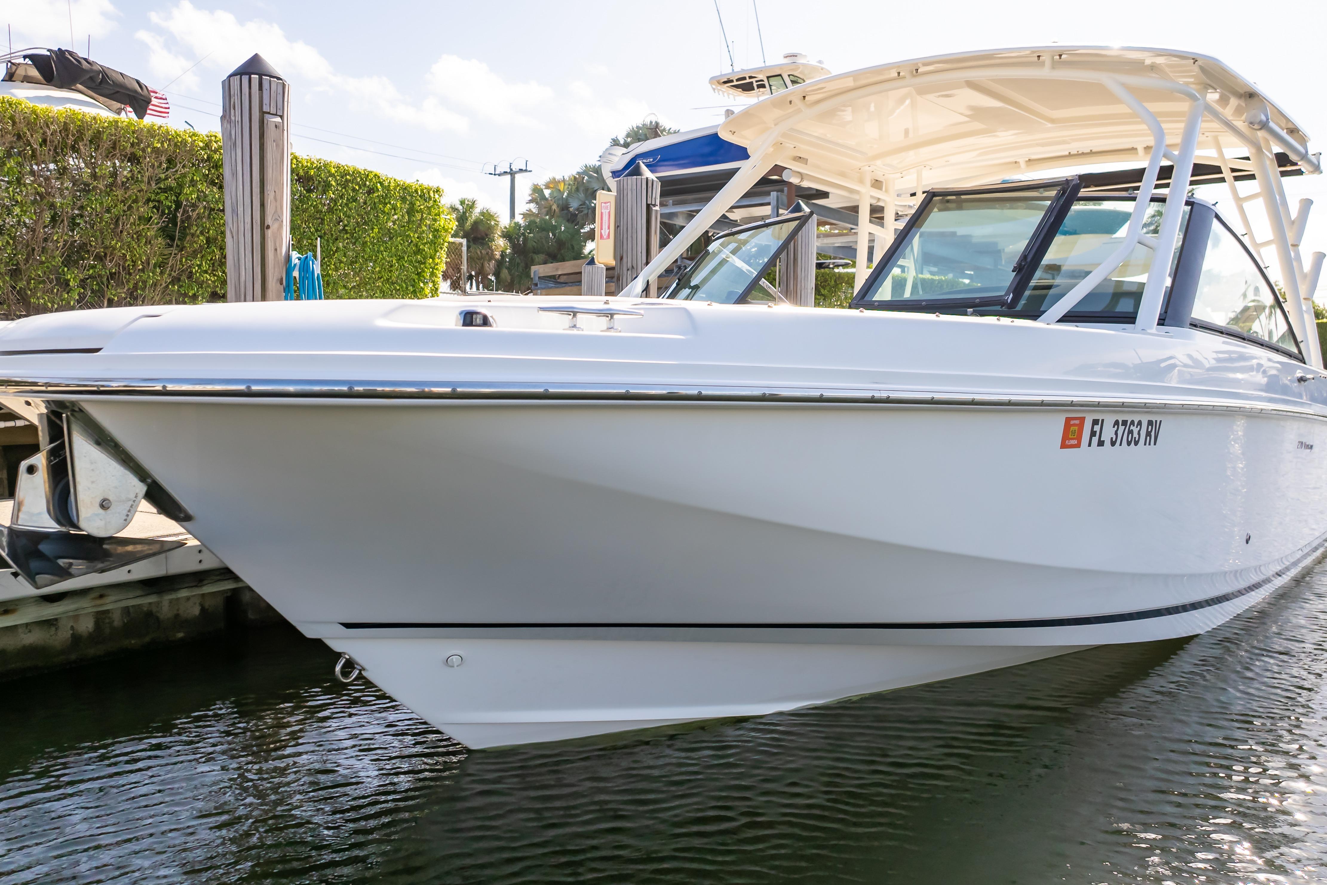 2019 Boston Whaler 270 Vantage boat docked in sunny marina setting.