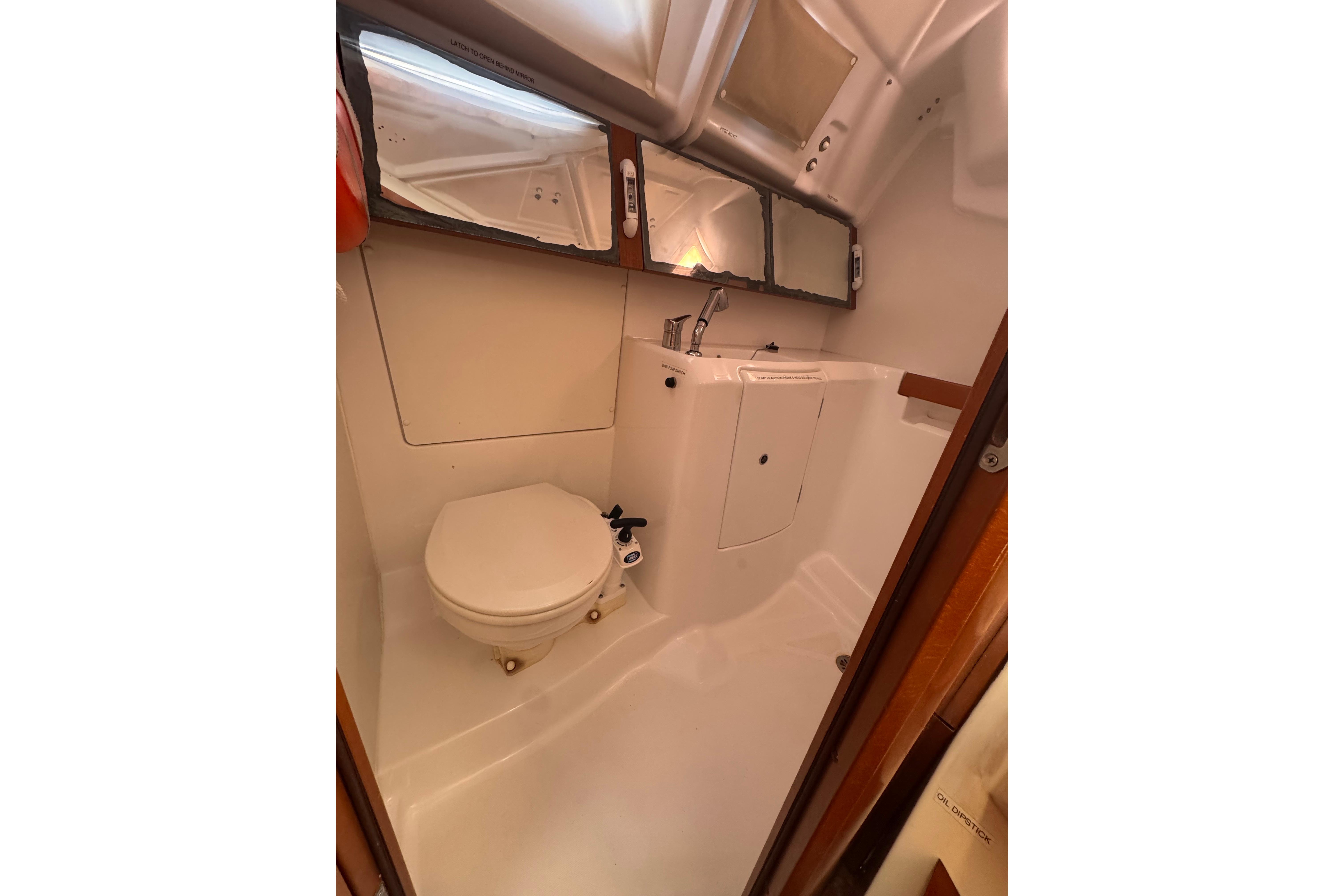 Interior of 2014 Beneteau Oceanis 34 yacht bathroom with toilet and sink.
