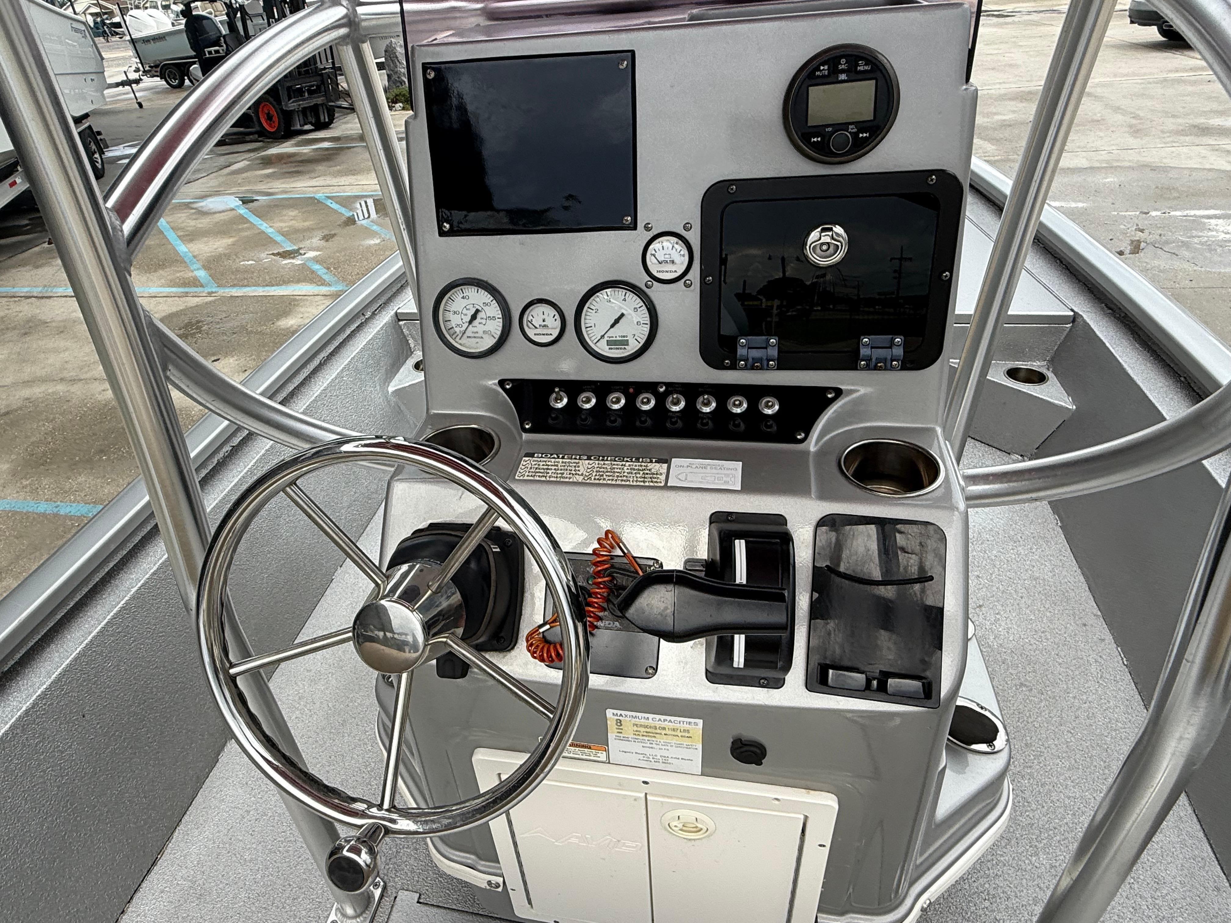 Control panel of 2020 Avid 23 FS Platinum boat with steering wheel and gauges.