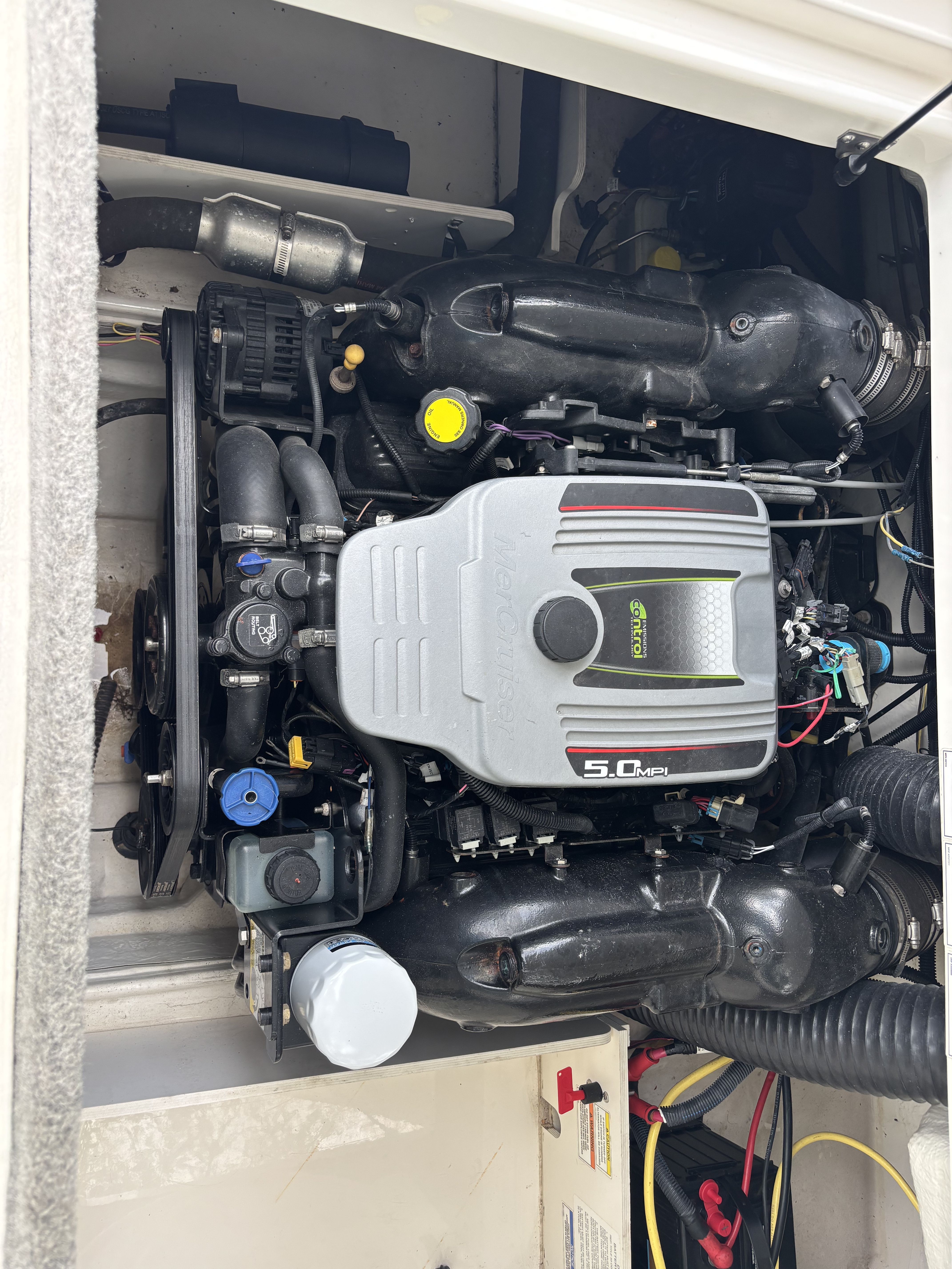 An engine compartment with a 5.0 MPI engine in a Bayliner boat.
