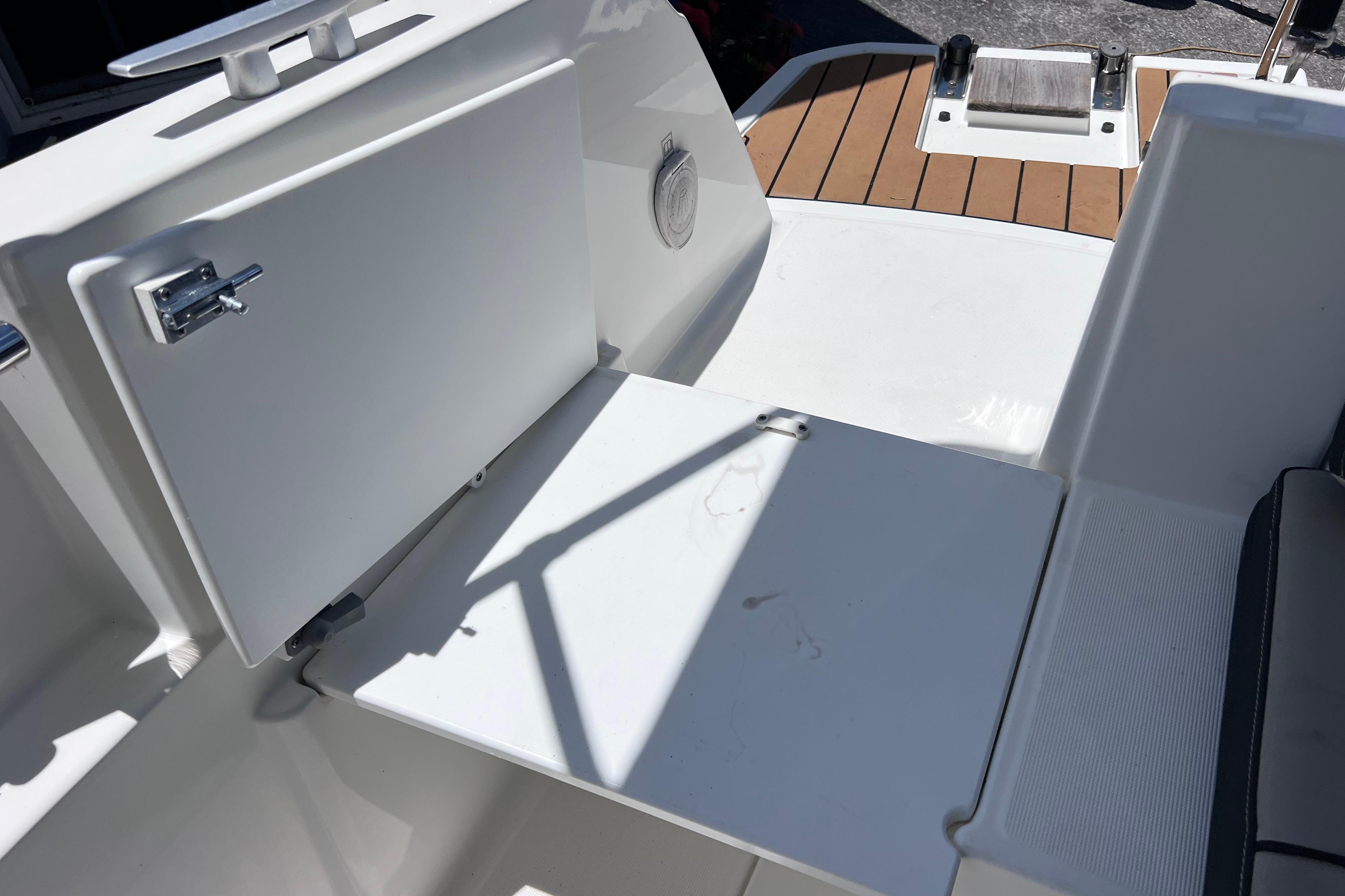 Interior view of 2021 Jeanneau NC Weekender 795 Series 2 boat, featuring seating and storage.