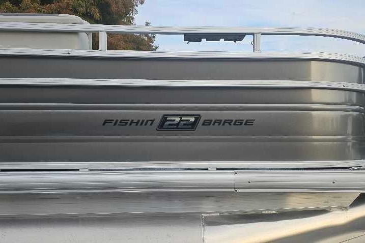 2026 Sun Tracker Fishin' Barge 22 DLX pontoon boat side view.